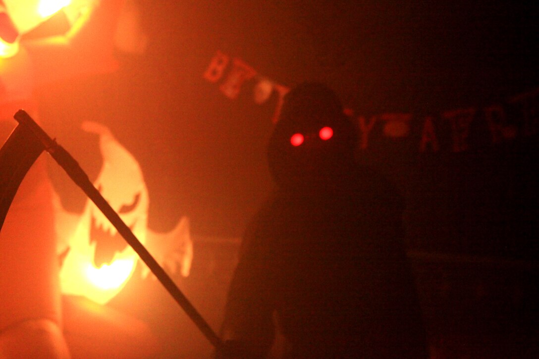 A Grim Reaper waits for visitors to Combat Logistics Regiment 27, 2nd Marine Logistics Group’s haunted house aboard Camp Lejeune, N.C., Oct. 21, 2012. Volunteers from the unit dressed in an assortment of haunted apparel to entertain the regiment’s families and build cohesion within the unit.
