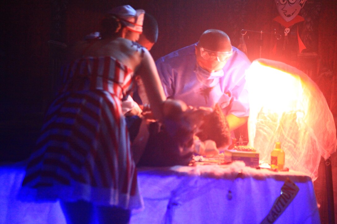 A wicked doctor and nurse operate on an unhappy patient during Combat Logistics Regiment 27, 2nd Marine Logistics Group’s haunted house aboard Camp Lejeune, N.C., Oct. 21, 2012. The regiment gathered families at its main building and treated them to a free haunted house and games. 
