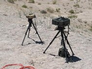 OP Left, 29 Palms, CA, 29 June 2011, Expeditionary Warfare Training Group, Pacific (EWTGPAC) Tactical Air Control Party Fire Exercise (TACP FIREX). This image shows the drastic size and weight reduction accomplished by PM FSS from one generation of Laser Target Designator to the next.  On the left is an Elbit AN/PEQ-19 Joint Terminal Attack Controller Laser Target Designator (JTAC LTD).  On the right is an Elbit AN/PEQ-17 Portable Lightweight Designator Rangefinder (PLDR) fielded by PM FSS just a few years earlier as a Program of Record (POR).  Photo: Joshua Culp.
