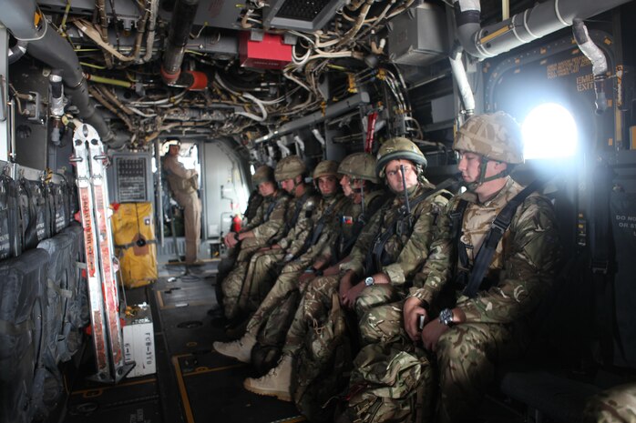 British Joint Terminal Attack Controllers aboard an MV-22B Osprey with Marine Medium Tiltrotor Squadron 162 wait to be dropped off at the landing zone where they will conduct training with U.S. Marines, Oct. 17. The training mimics conditions in theater where armed forces of different countries work together to achieve a goal.