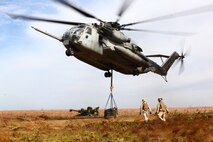 A CH-53E Super Stallion from Marine Heavy Helicopter Squadron 464 hovers over a pallet of M777 howitzer ammunition as the helicopter support team works to connect the pallet to the single-point hook of the Super Stallion, Oct. 17. Marines from HMH-464 participated in the flight to train on external cargo transport. 