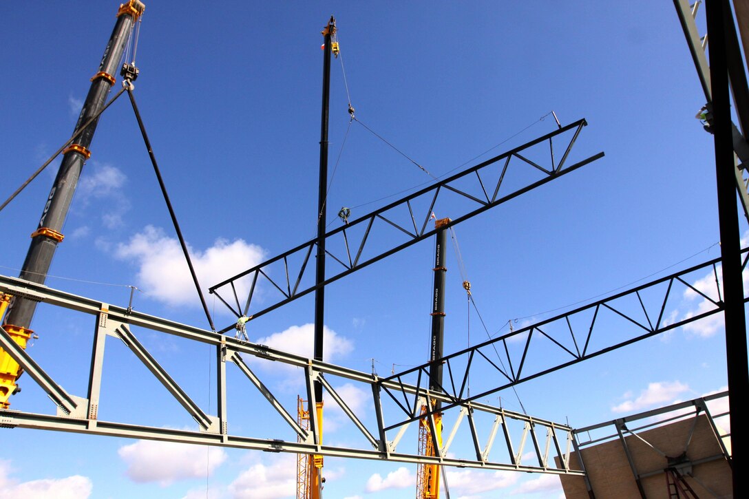 A connector with Pro Steel Erectors guides a supporting truss, which will stabilize the 81-ton single-plain truss that spans across Hangar 1 Alpha at Marine Corps Air Station Camp Pendleton Oct. 24. Two, 100-foot cranes were required to lift the 237-foot-long, 17-foot-tall single-plain truss. The hangar will provide Marine Aviation Logistics Squadron 39 depot level maintenance a permanent facility to work out of. Depot-level maintenance is currently being conducted at a number of temporary facilities, and this facility will also greatly enhance space efficiencies along the flight line.