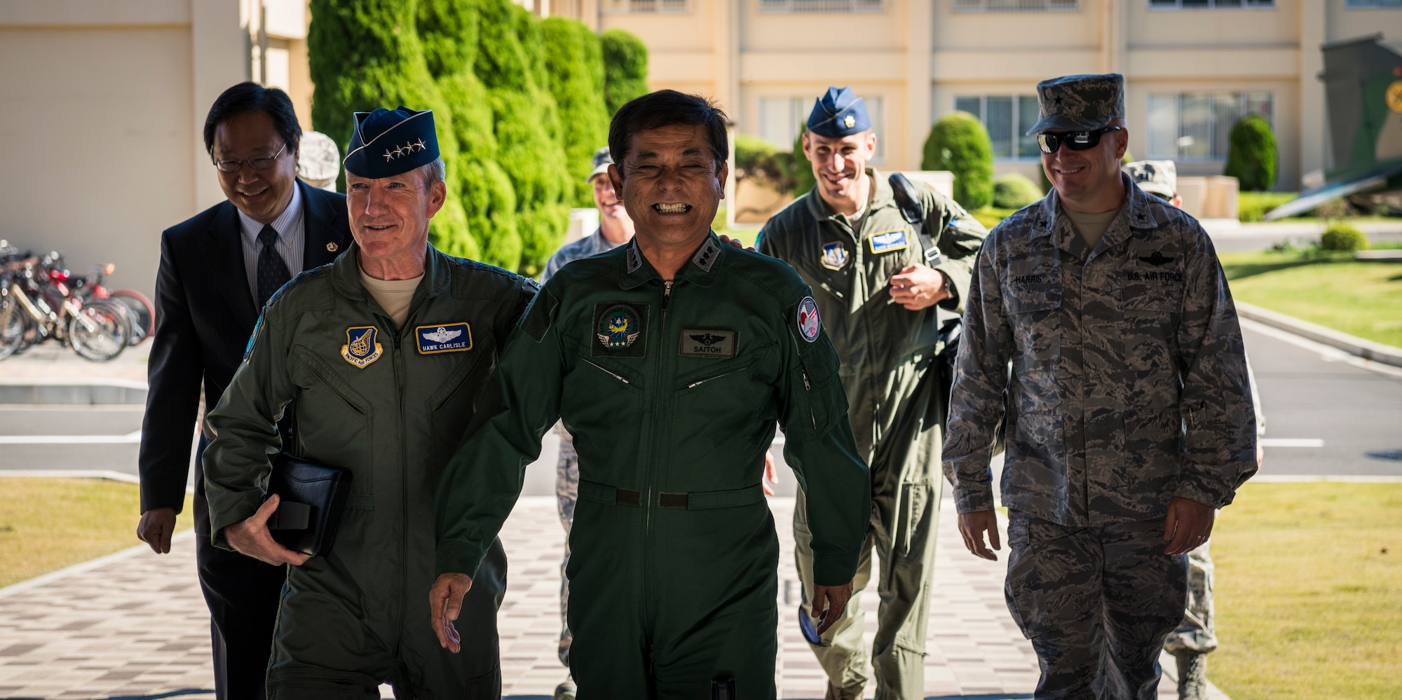 YOKOTA AIR BASE, Japan -- Gen. Herbert J. "Hawk" Carlisle, left, Pacific Air Forces commander, shares a laugh with Japan Air Self-Defense Force Lt. Gen. Harukazu Saitoh, Air Defense Command commander, as they walk into the ADC headquarters building at Yokota Air Base, Japan, Oct. 23, 2012. The ADC was originally headquartered at Fuchu Air Base but moved to a new facility built at Yokota. (U.S. Air Force photo by Tech. Sgt. Samuel Morse)