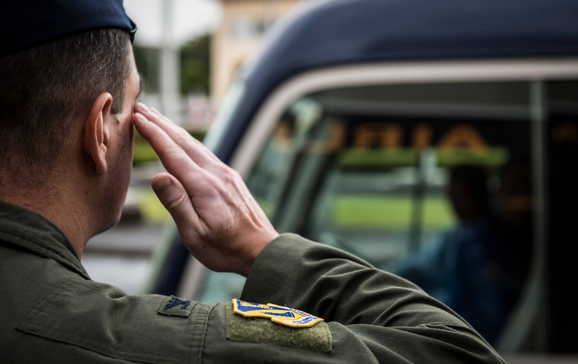 YOKOTA AIR BASE, Japan -- Col. Mark August, 374th Airlift Wing commander, salutes a van carrying Gen. Herbert J. "Hawk" Carlisle, Pacific Air Forces commander, outside the wing headquarters building at Yokota Air Base, Japan, Oct. 23, 2012. Carlisle visited military facilities in downtown Tokyo before flying out to Yokota to learn about the Airmen and their mission. (U.S. Air Force photo by Tech. Sgt. Samuel Morse)