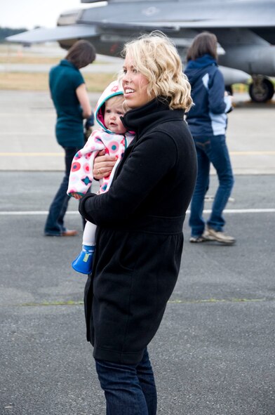 Joselyn O’Reilly holds her daughter and waits for her husband, Maj. Bill O’Reilly, 14th Fighter Squadron assistant director of operations, to get out of the F-16 Fighting Falcon aircraft at Misawa Air Base, Japan, Oct. 25, 2012. Misawa’s pilots, maintainers and additional support staff, along with several F-16 Fighting Falcon aircraft, were deployed to Afghanistan for the last three months. (U.S. Air Force photo by Airman 1st Class Kenna Jackson)