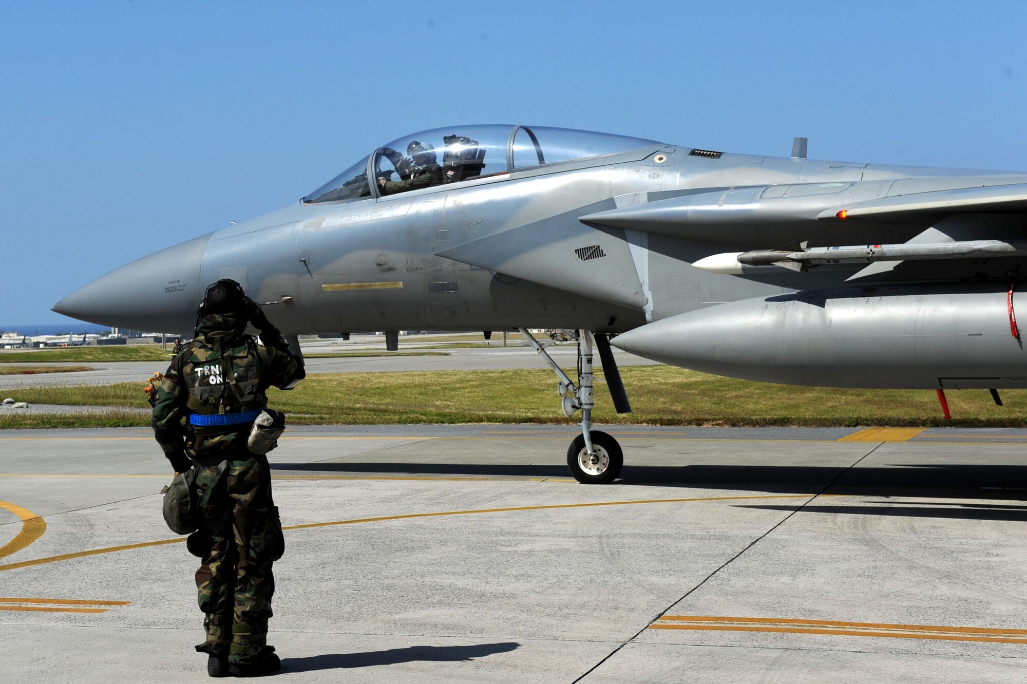 U.S. Air Force Airman 1st Class Najee Jarrett, 18th Aircraft Maintenance Squadron maintainer, salutes U.S. Air Force Capt. Tyler Marsh, 44th Fighter Squadron fighter pilot, as he taxies out to the runway during Exercise Beverly Bearcat 12-1, a Pacific Air Forces readiness inspection, on Kadena Air Base, Japan, Oct. 25, 2012. The inspection is being conducted to see if Kadena Airmen are ready for real-world contingencies. (U.S. Air Force photo/Airman 1st Class Brooke P. Beers)