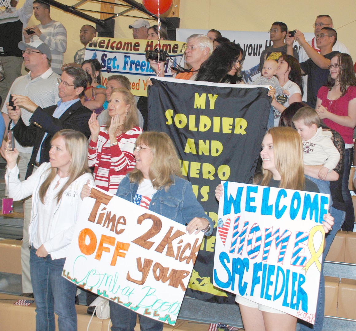 Full of anticipation, family members in the bleachers watch for their Soldiers as the 14th Military Intelligence Battalion forms up in the Fort Sam Houston Teen Center gymnasium. The battalion returned Oct. 21 after a year in Afghanistan.
Photo by Gregory Ripps
