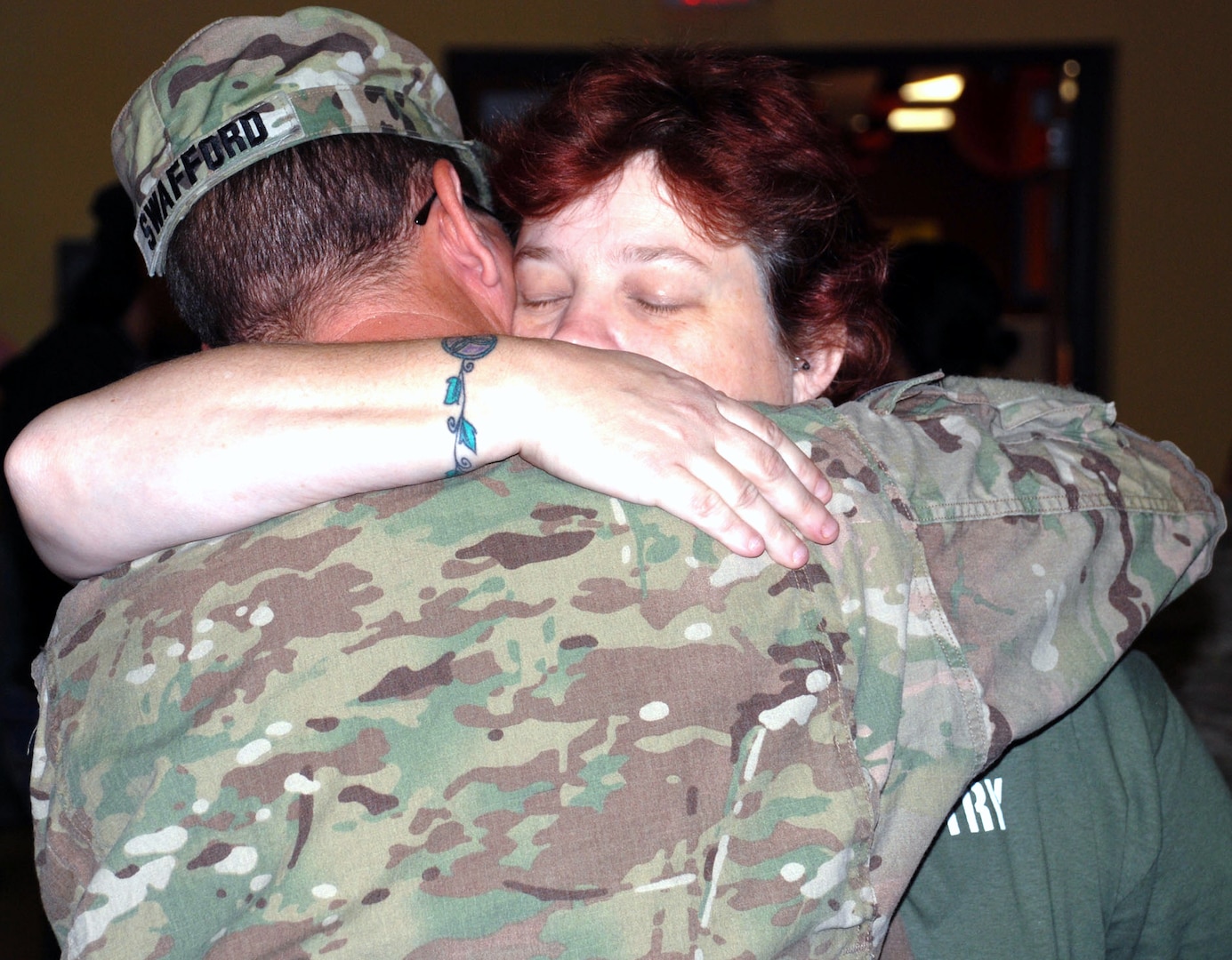 Family members greet Soldiers with hugs and kisses after the 14th Military Intelligence Battalion was dismissed. The Soldiers will have some reintegration training during their first week home, then have 30 days of leave before resuming their military duties.
Photo by Gregory Ripps