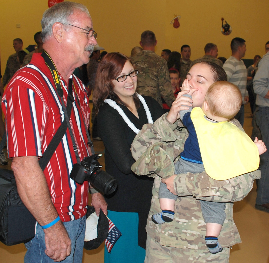 Family members greet Soldiers with hugs and kisses after the 14th Military Intelligence Battalion was dismissed. The Soldiers will have some reintegration training during their first week home, then have 30 days of leave before resuming their military duties.
Photo by Gregory Ripps