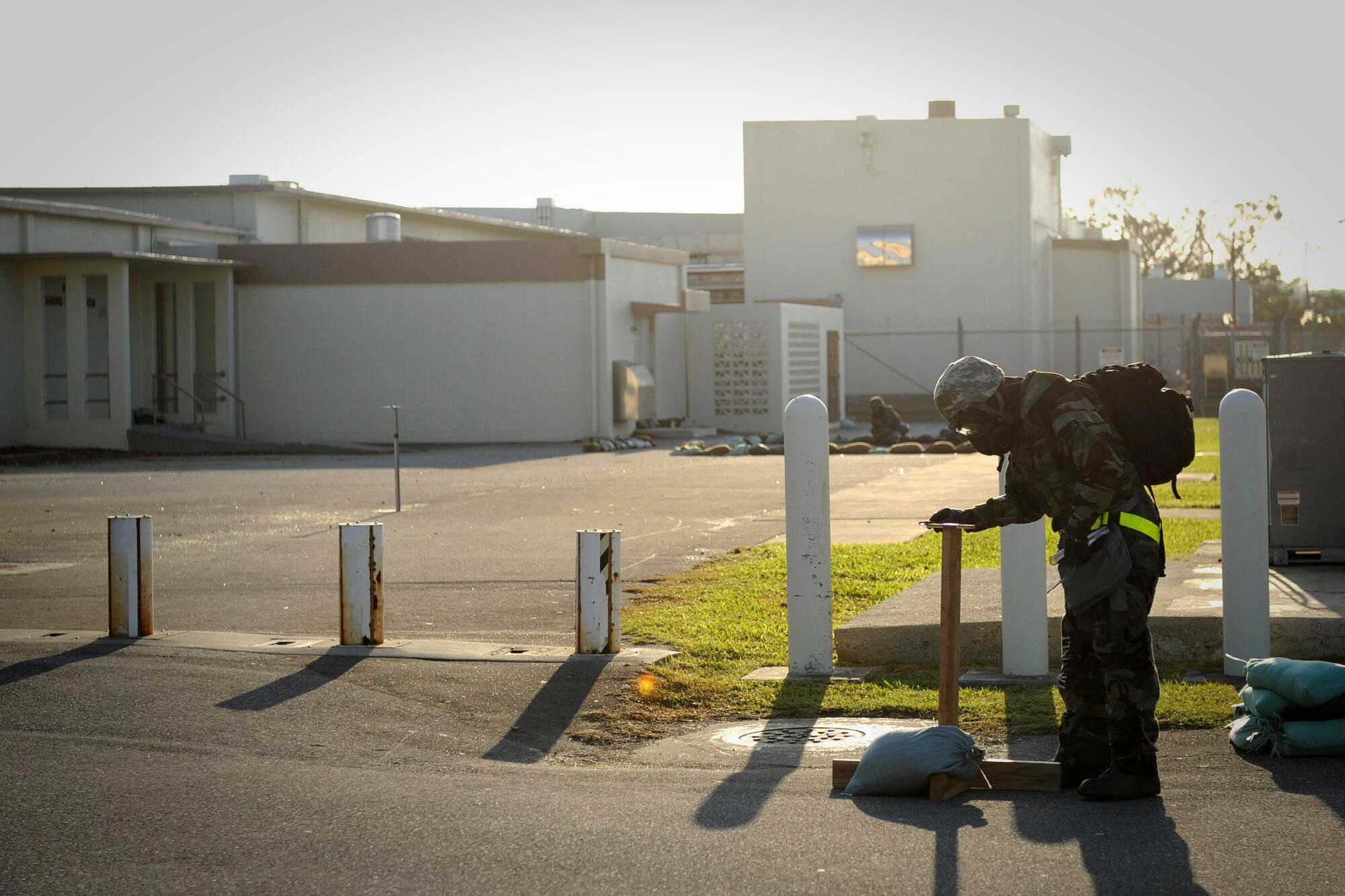 U.S. Air Force Staff Sgt. Laszlo Babosci, 18th Wing Public Affairs photographer, checks a post attack reconnaissance stand for contamination after a simulated attack during a Pacific Air Forces readiness inspection, Exercise Beverly Bearcat 12-1, on Kadena Air Base, Japan, Oct. 25, 2012. PACAF has been conducting a readiness Inspection to test 18th Wing Airmen on their ability to conduct real-world contingencies. (U.S. Air Force photo/Airman 1st Class Brooke P. Beers)