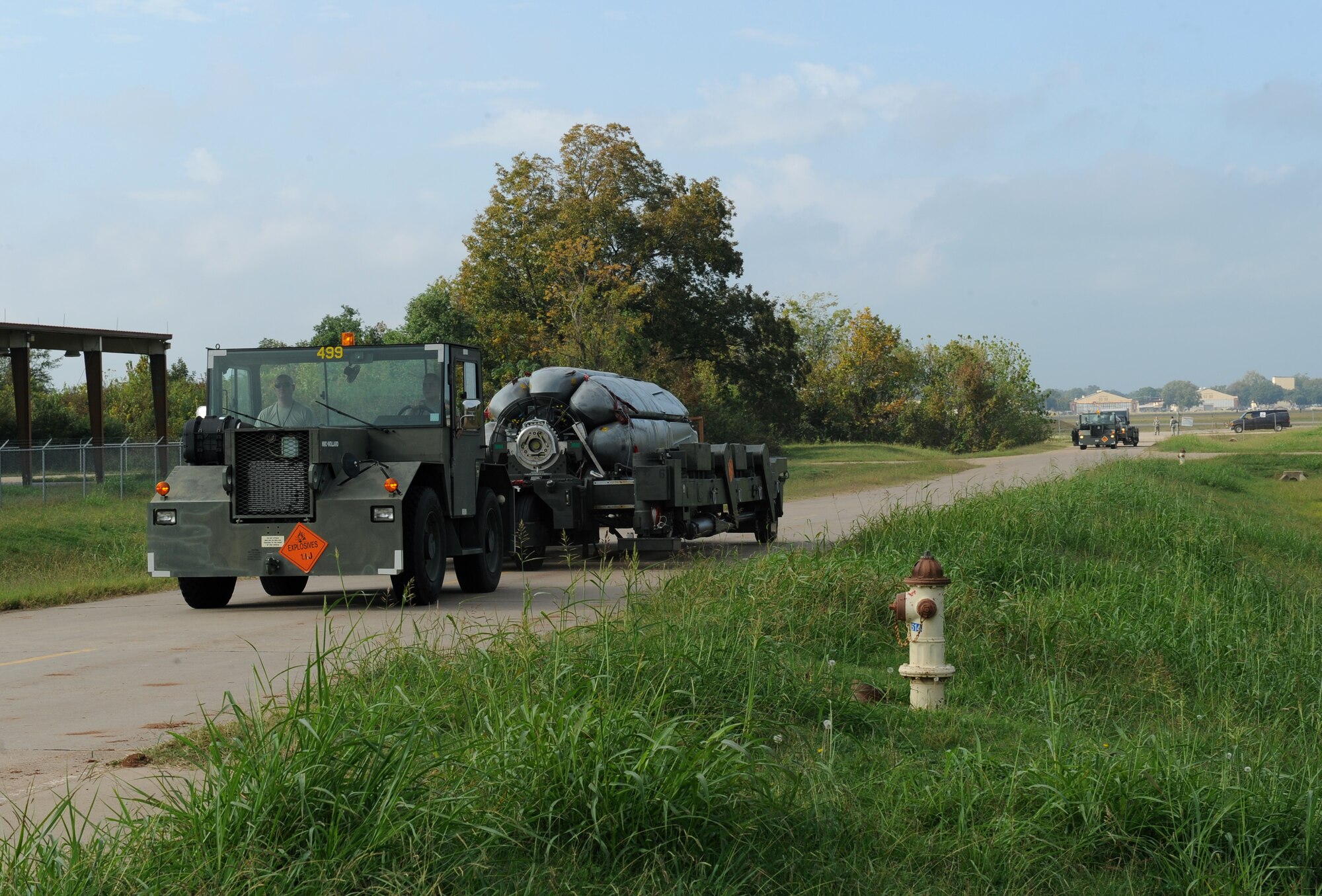 Two MB-4 tugs transporting common strategic rotary launchers, each holding eight Conventional Air-Launched Cruise Missiles, return from the flightline during a CALCM generation exercise on Barksdale Air Force Base, La., Oct 25. During the exercise, 2nd Munitions Squadron Airmen simulated the breakout and transportation of CALCMs to demonstrate their readiness in the event of an actual incident. (U.S. Air Force photo/Airman 1st Class Benjamin Gonsier)(RELEASED)
