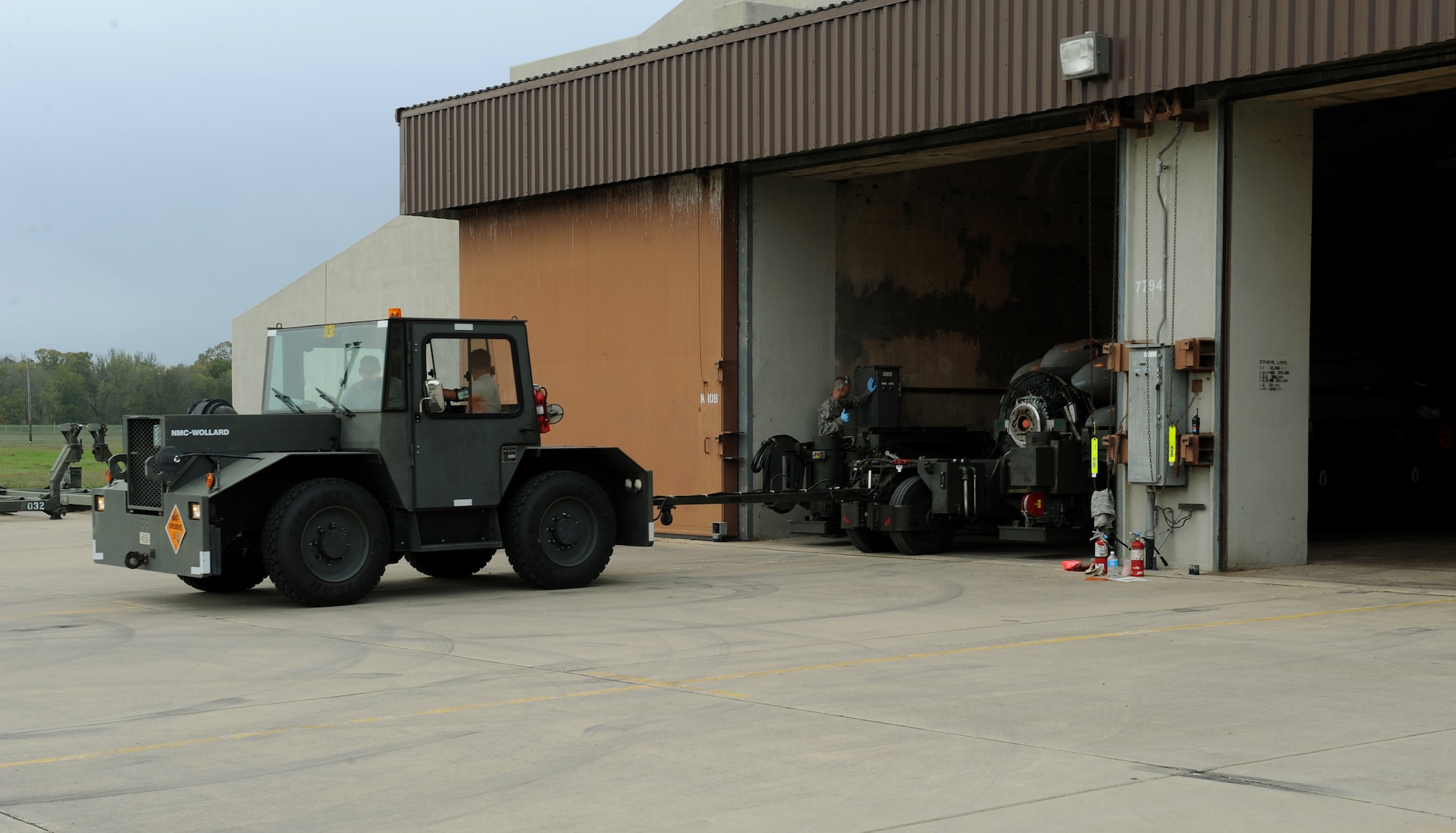 An MB-4 tug pulls an MHU-196 holding a common strategic rotary launcher containing eight Conventional Air-Launched Cruise Missiles during a CALCM generation exercise on Barksdale Air Force Base, La., Oct. 25. An MHU-196 can hold a maximum of 40,000 pounds. Each CALCM weighs approximately 3,500 pounds. (U.S. Air Force photo/Airman 1st Class Benjamin Gonsier)(RELEASED)
