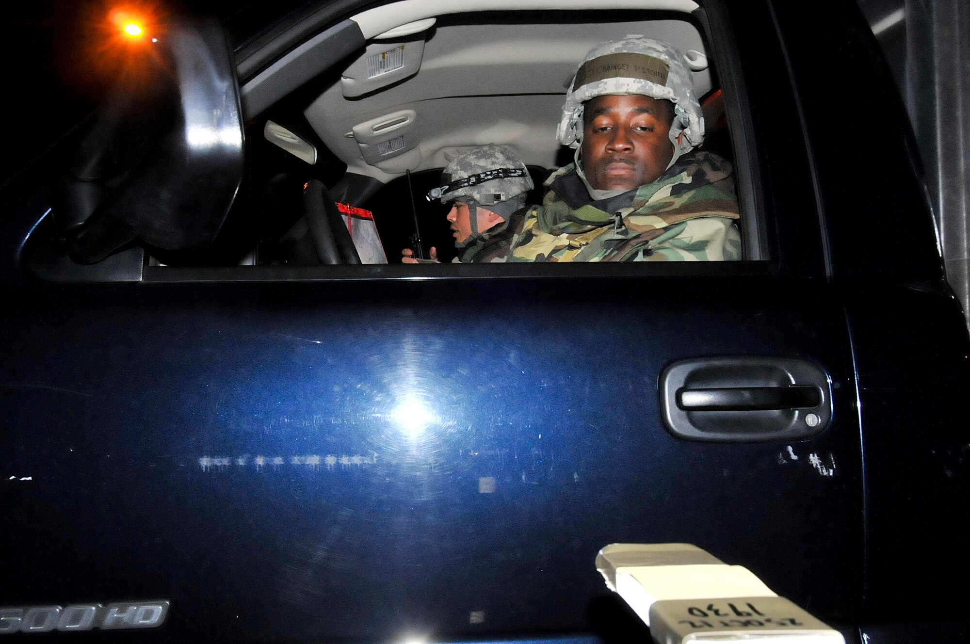 U.S. Air Force Staff Sgt. Chauncey Mitchell, 18th Civil Engineer Squadron readiness support team member, checks the chemical stand for contaminates as U.S. Air Force Tech. Sgt. Giles Dame, 18th Civil Engineer Squadron readiness support team member, passes the information to their office during the fifth day of a Pacific Air Forces readiness inspection on Kadena Air Base, Japan, Oct. 24, 2012. This inspection will test the 18th Wing on its ability to survive and operate in a contingency. The readiness support teams ensures that Kadena are informed about the chemical conditions of each zone and checks each zones to ensure it isn't contaminated. (U.S. Air Force photo/Staff Sgt. Darnell T. Cannady)