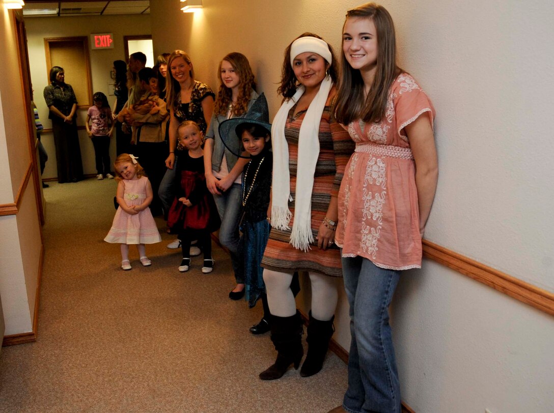 Models line up as they prepare to strut their stuff during the B-One Yard Thrift Store Volunteer Recognition Fashion Show event at the Chapel Activities Center at Ellsworth Air Force Base, S.D., Oct. 18, 2012. Each model wore clothing donated to the B-One Yard Thrift and Consignment store to help promote the store and build their customer base. (U.S. Air Force photo by Airman 1st Class Anania Tekurio/Released) 