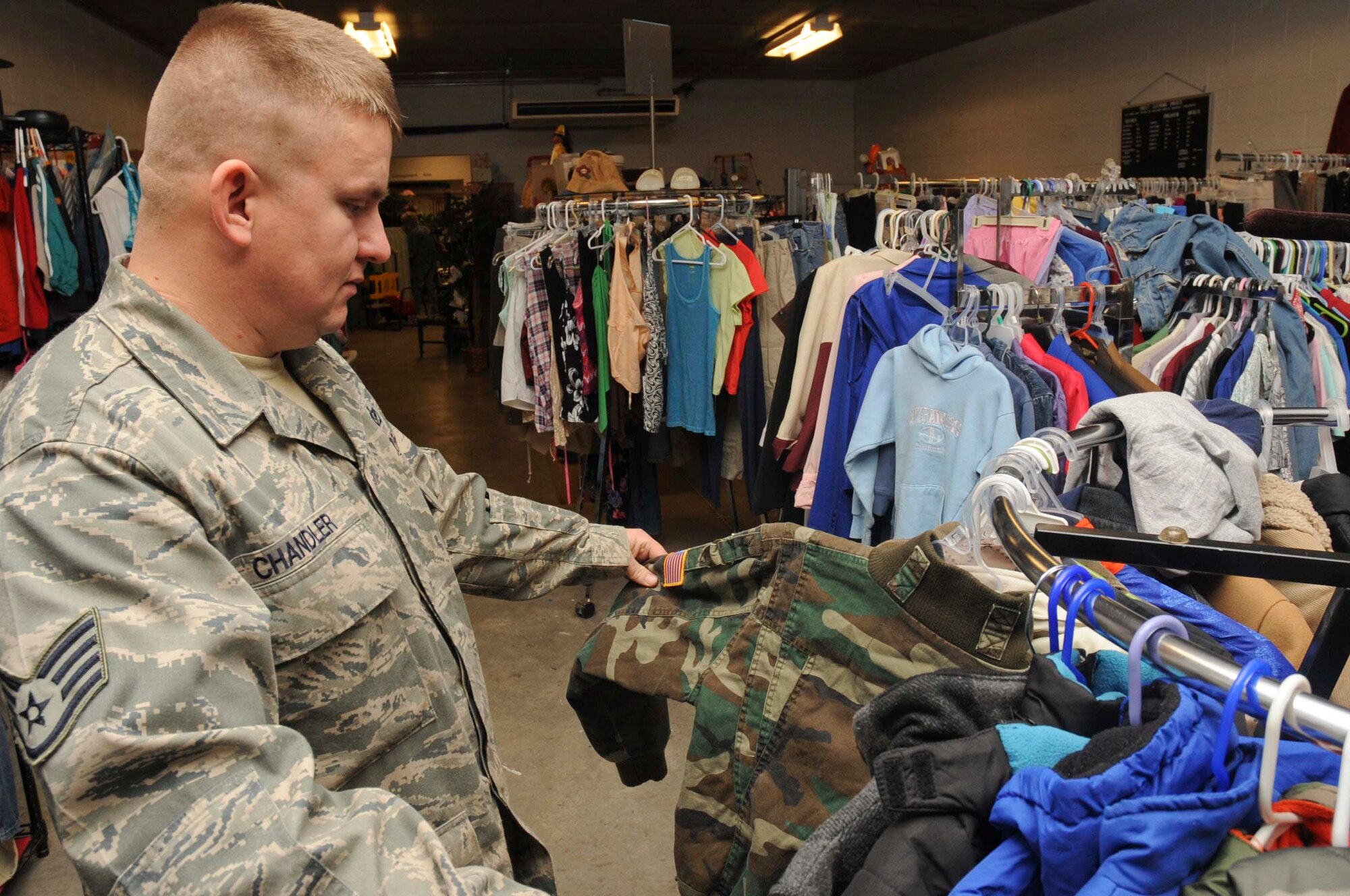 Staff Sgt. Joseph Chandler, 28th Civil Engineer Squadron pavement and equipment operator, sorts through clothes inside the B-One Yard Thrift and Consignment store at Ellsworth Air Force Base, S.D., Oct. 16, 2012. The B-One Yard Thrift store offers several programs geared toward providing Airmen with necessary and comfort of life items  . (U.S. Air Force photo by Airman 1st Class Anania Tekurio/Released) 
