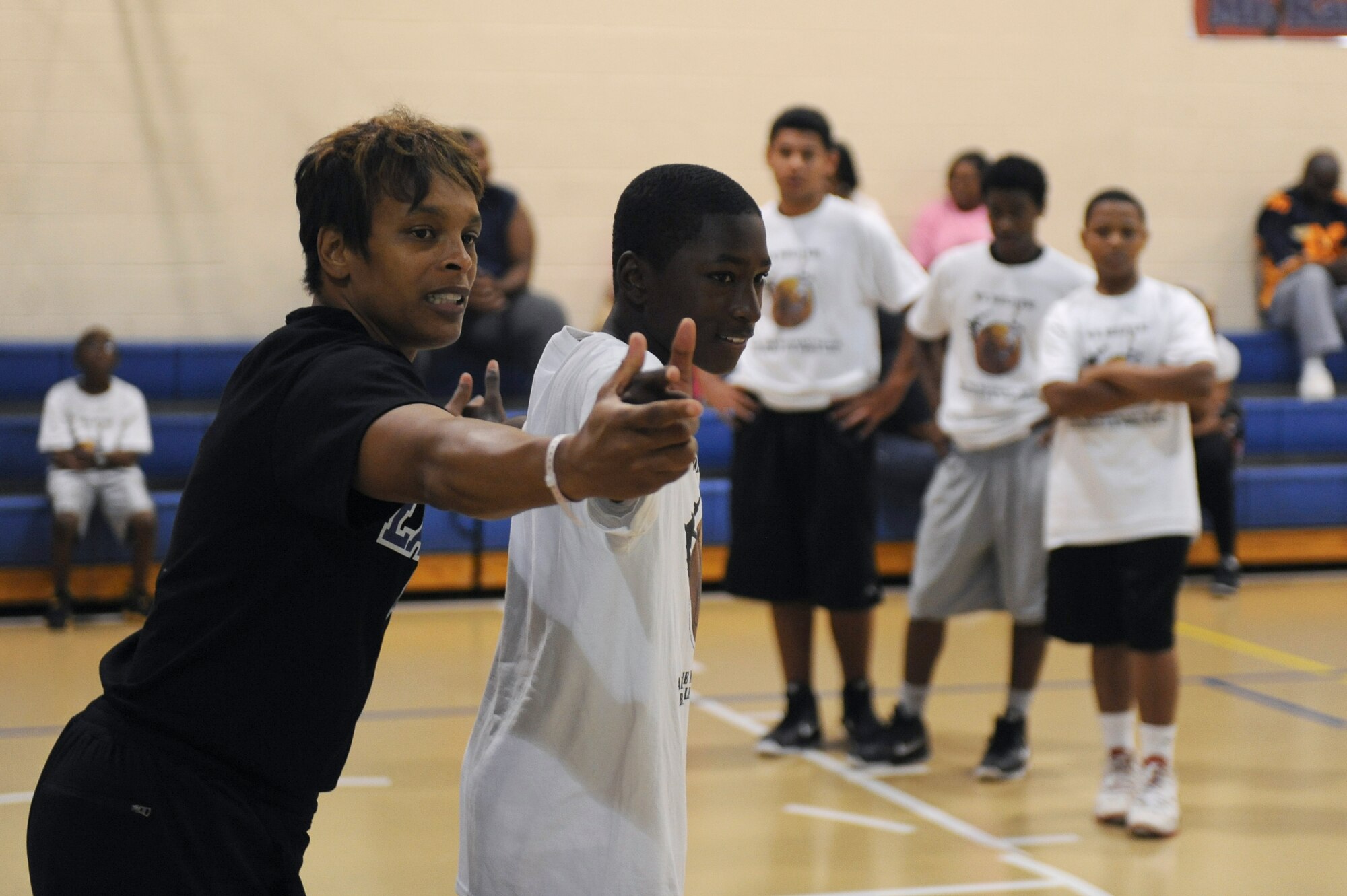 Teresa Weatherspoon, Louisiana Tech women?s basketball coach and retired WNBA player, shows participants in the Karl Malone Basketball Clinic how to play defense on Barksdale Air Force Base, La., Oct. 20. Participants in the clinic were able to learn drills, participate in team building exercises, compete in a shooting contest, scrimmage and have a photo taken with Malone. (U.S. Air Force photo/Senior Airman Micaiah Anthony)(RELEASED)