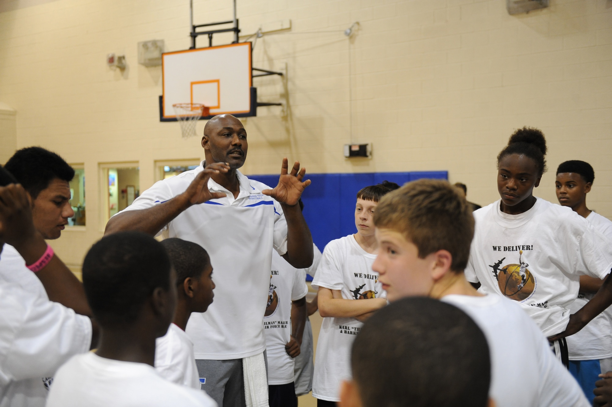 Karl Malone, retired NBA player, speaks to some of Barksdale?s youth about the fundamentals of basketball on Barksdale Air Force Base, La., Oct. 20. Participants in the clinic were able to learn drills, participate in team building exercises, compete in a shooting contest, scrimmage and have a photo taken with Malone. (U.S. Air Force photo/Senior Airman Micaiah Anthony)(RELEASED)