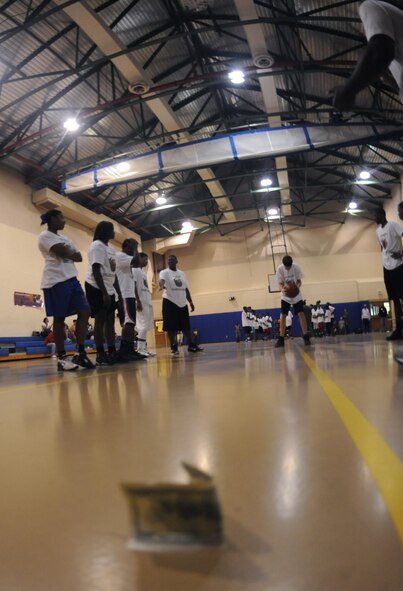One of Barksdale?s youth concentrates before shooting a free-throw during the Karl Malone Basketball Clinic on Barksdale Air Force Base, La., Oct. 20. To challenge the participants, Malone set a $100 bill under the goal and told the kids if they made two free-throws in a row that they could keep the money. Malone explained the importance of focus and striving for excellence after several participants made the shots. (U.S. Air Force photo/Senior Airman Micaiah Anthony)(RELEASED)