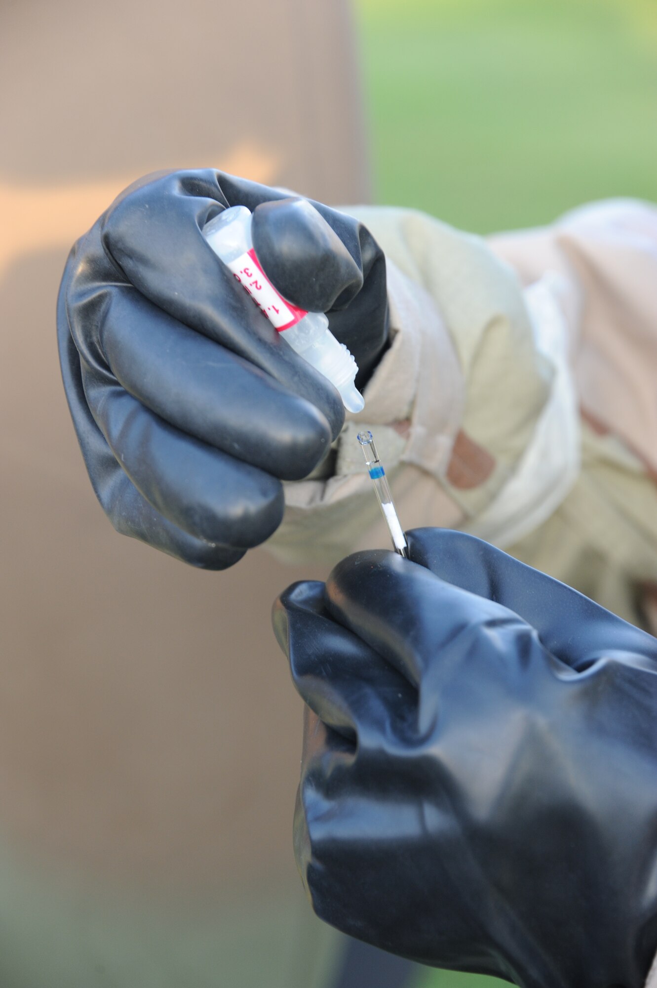 1st Lt. Thomas Dominguez, 87th Aerospace Medicine Squadron environmental engineer, hailing from Harlingen, Texas, test water for chemical agents during the operational readiness exercise, Oct. 14, here. Dominguez was able to test for Lucite, mustard gas and other nerve agents. (U.S. Air Force photo by 2nd Lt. David Murphy/Released)