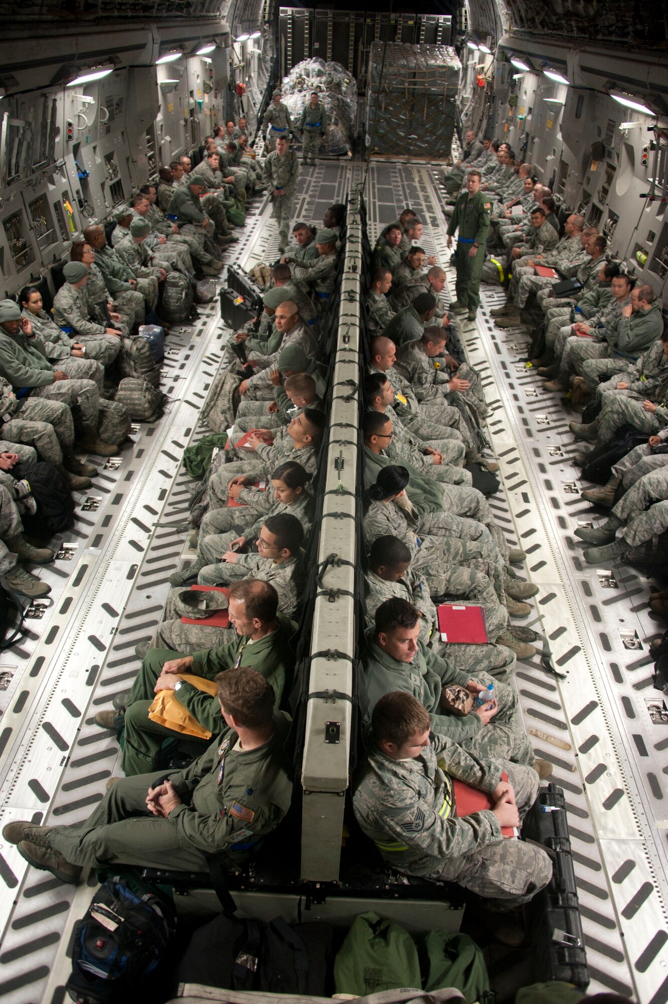Service members from 87th Air Base Wing and 514th Air Mobility Wing prepare to deploy on a C-17 Globemaster III during a home-station operational readiness exercise Oct. 12 here. The week-long exercise is designed to give service members the opportunity to test their ability to go through the deployment, employment and redeployment process. (U.S. Air Force photo by 2nd Lt. David Murphy/Released)