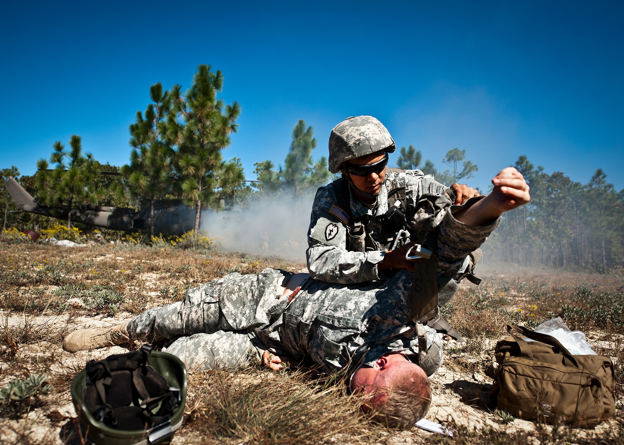 Sgt. 1st Class Brian Thomas, of the 6th Ranger Training Battalion, removes a Soldier's gear to evaluate his injuries during a downed aircraft exercise on the Eglin range, Oct. 20.  The 6 RTB, Team Eglin’s emergency responders and local medical facilities participated in the exercise that simulated a helicopter crash with 12 Soldiers injured deep within the Eglin range.  The victims were either evacuated by helicopter or by ambulance to area hospitals.  The annual exercise was to validate the battalion’s emergency procedures and test their communication with Team Eglin and local emergency and medical units.  (U.S. Air Force photo/Samuel King Jr.)