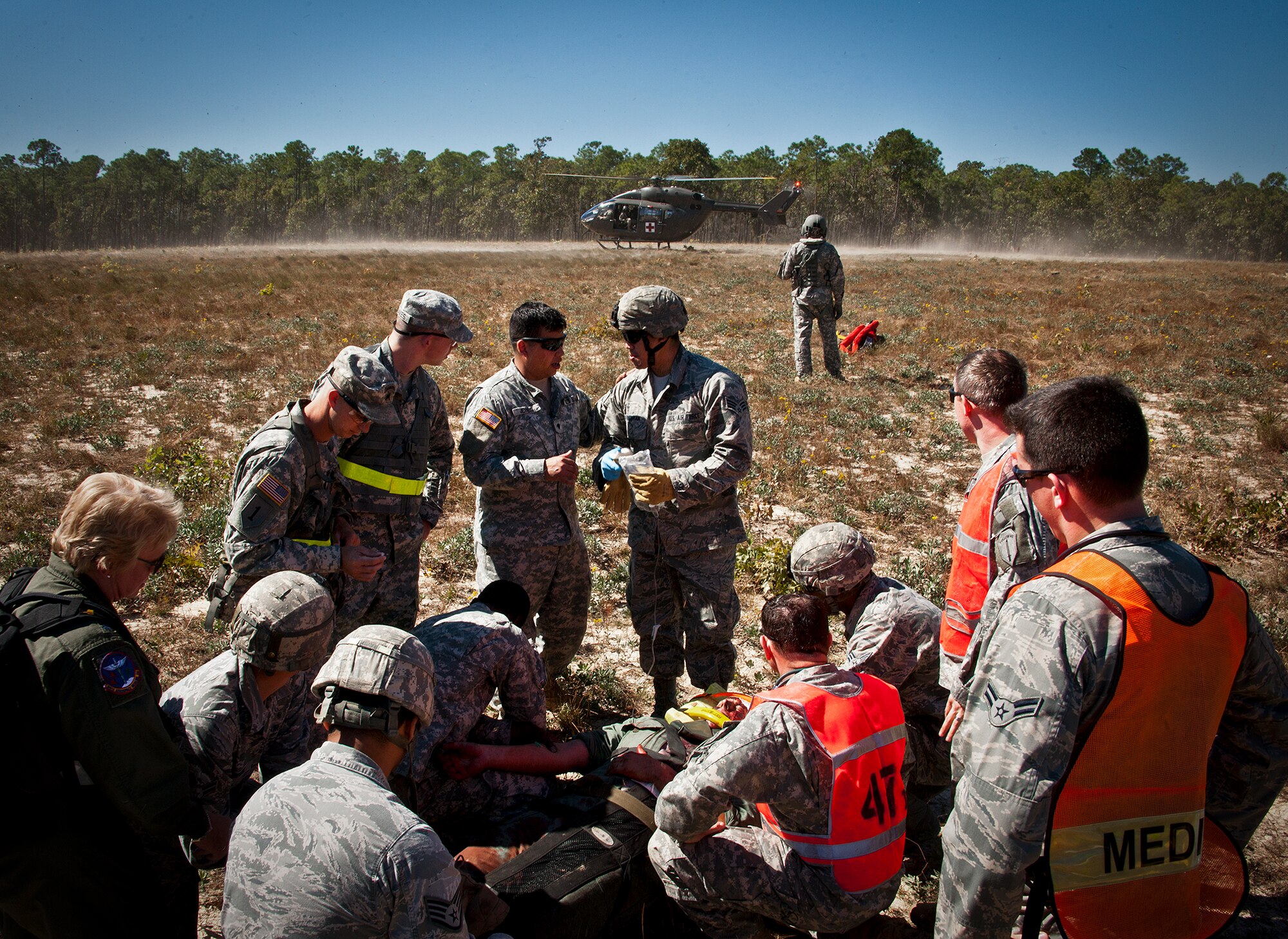 Army and Air Force medics prepare to move a simulated victim to the medical evacuation helicopter during a downed aircraft exercise on the Eglin range, Oct. 20.  The 6th Ranger Training Battalion, Team Eglin’s emergency responders and local medical facilities participated in the exercise that simulated a helicopter crash with 12 Soldiers injured deep within the Eglin range.  The victims were either evacuated by helicopter or by ambulance to area hospitals.  The annual exercise was to validate the battalion’s emergency procedures and test their communication with Team Eglin and local emergency and medical units.  (U.S. Air Force photo/Samuel King Jr.)