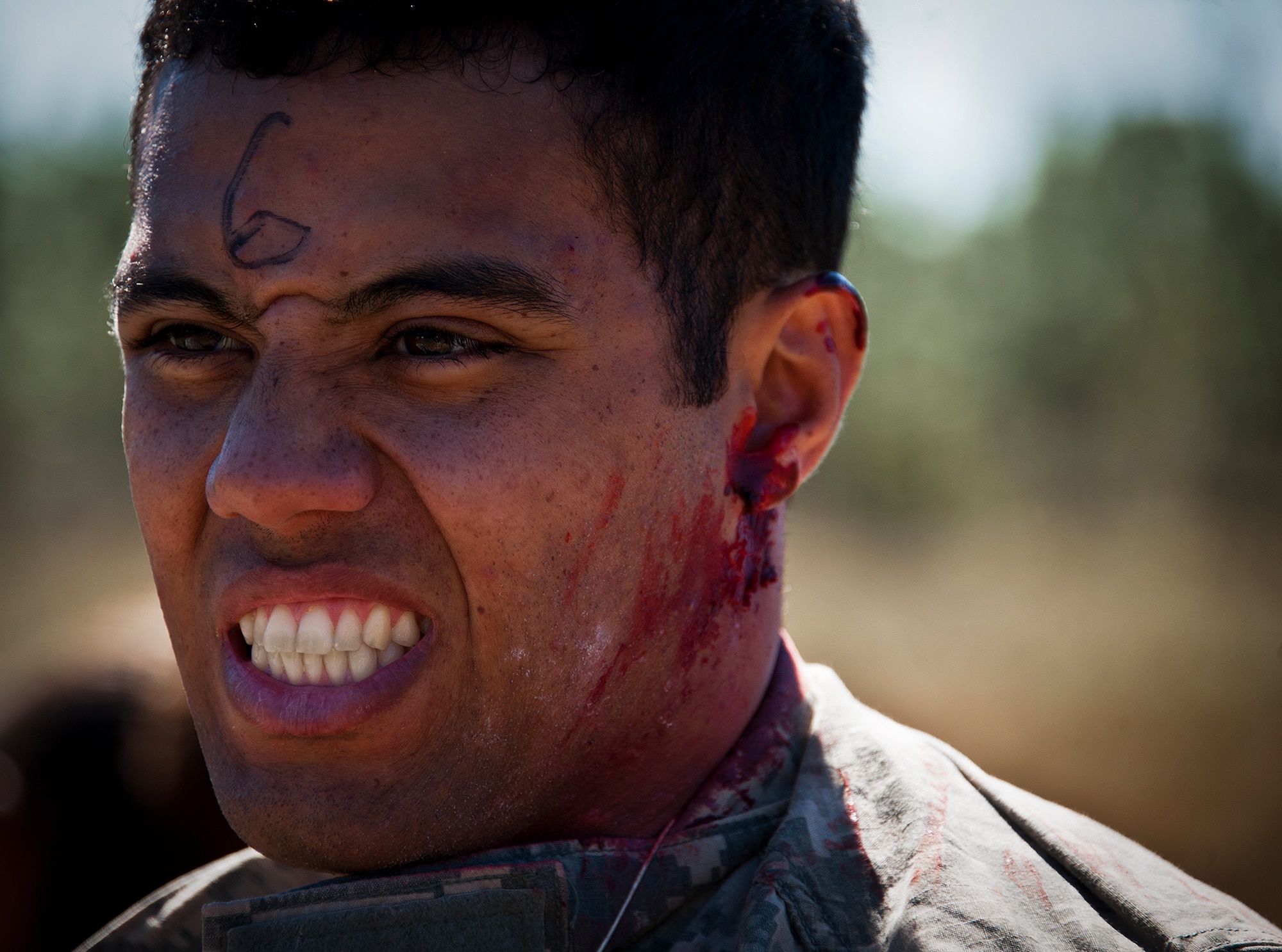 A simulated victim grimaces in pain as Army medics evaluate his injuries during a downed aircraft exercise on the Eglin range, Oct. 20.  The 6th Ranger Training Battalion, Team Eglin’s emergency responders and local medical facilities participated in the exercise that simulated a helicopter crash with 12 Soldiers injured deep within the Eglin range.  The victims were either evacuated by helicopter or by ambulance to area hospitals.  The annual exercise was to validate the battalion’s emergency procedures and test their communication with Team Eglin and local emergency and medical units.  (U.S. Air Force photo/Samuel King Jr.)