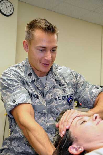 U.S. Air Force Lt. Col. (Dr.) Christian Lyons, 4th Medical Operations Squadron commander, stretches the neck of a patient at the Physical Therapy clinic on Seymour Johnson Air Force Base, N.C., Oct. 25, 2012. Lyons has been recognized twice by the Association of Military Surgeons of the United States for his case studies on patients with spinal complications. (U.S. Air Force photo/Senior Airman Gino Reyes/Released) 
