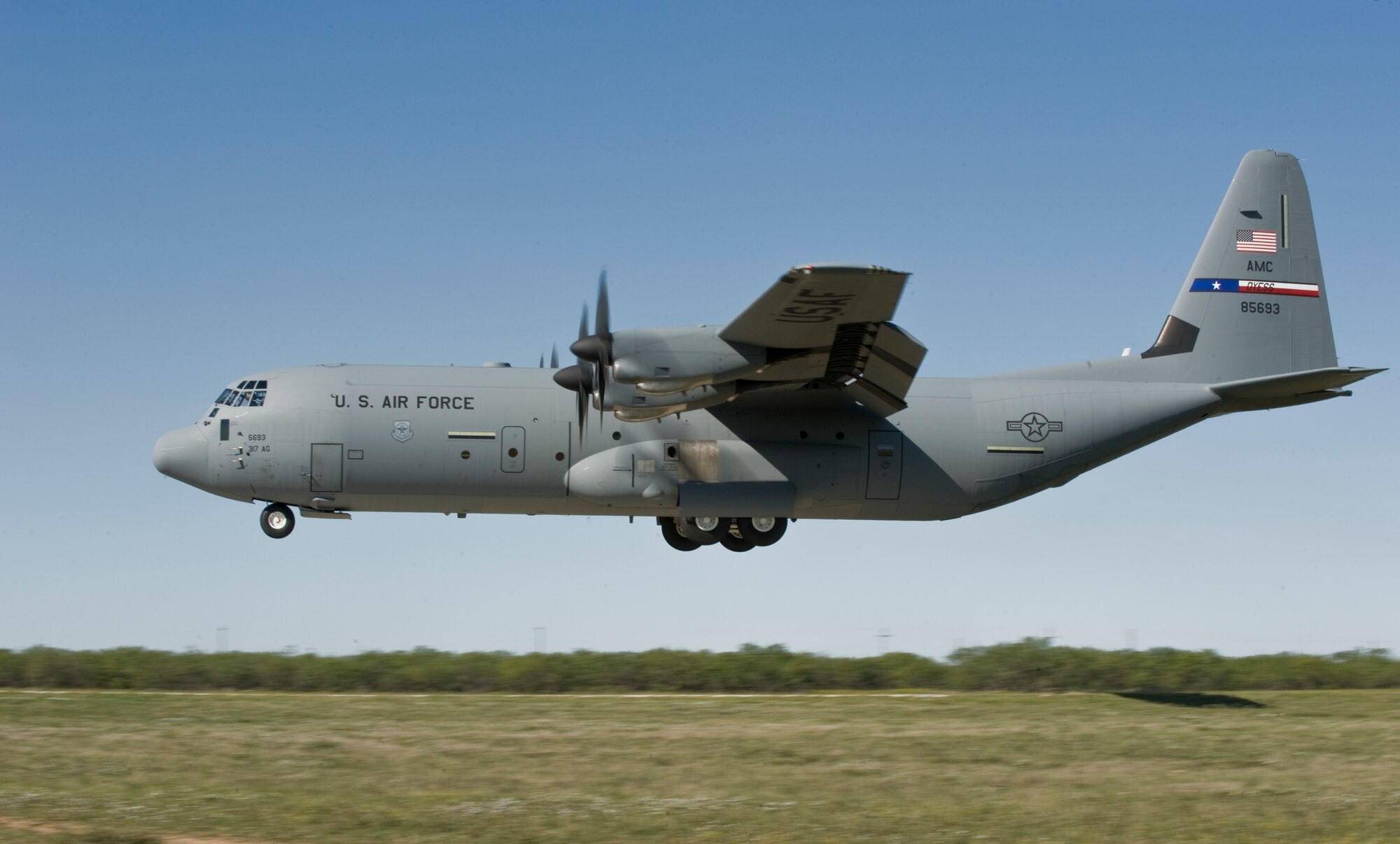 A C-130J demonstrates a tactical landing during Impact Day Oct. 19, 2012, at Dyess Air Force Base, Texas. Maintainers from the 317th Airlift Group learned the outcome of generating an aircraft when it flies and resupplies a drop zone. (U.S. Air Force photo by Airman 1st Class Jonathan Stefanko/ Released)