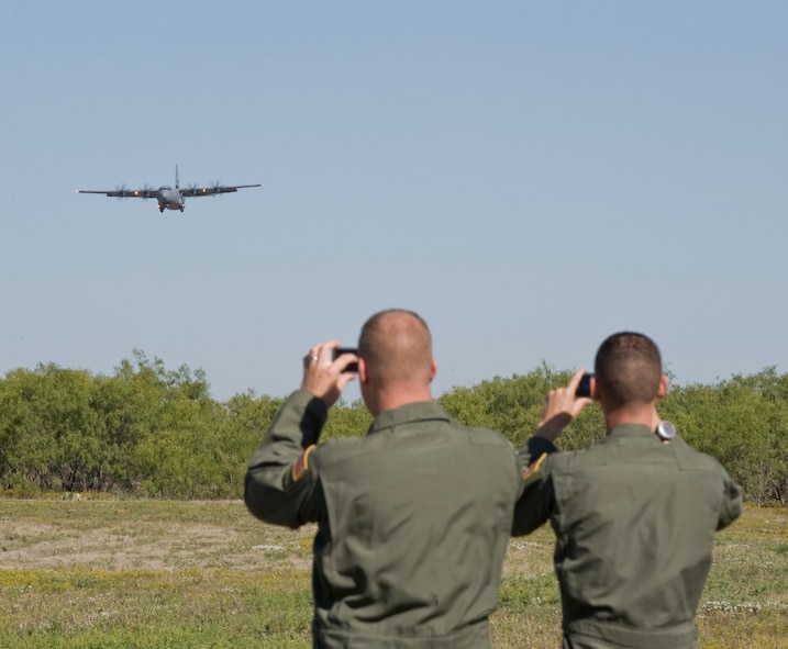 Airmen from the 317th Airlift Group watch a C-130J come in for a landing during Impact Day, Oct. 19, 2012, at Dyess Air Force Base, Texas. Maintainers from the 317th Airlift Group learned the outcome of generating an aircraft when it flies and resupplies a drop zone. (U.S. Air Force photo by Airman 1st Class Jonathan Stefanko/ Released)