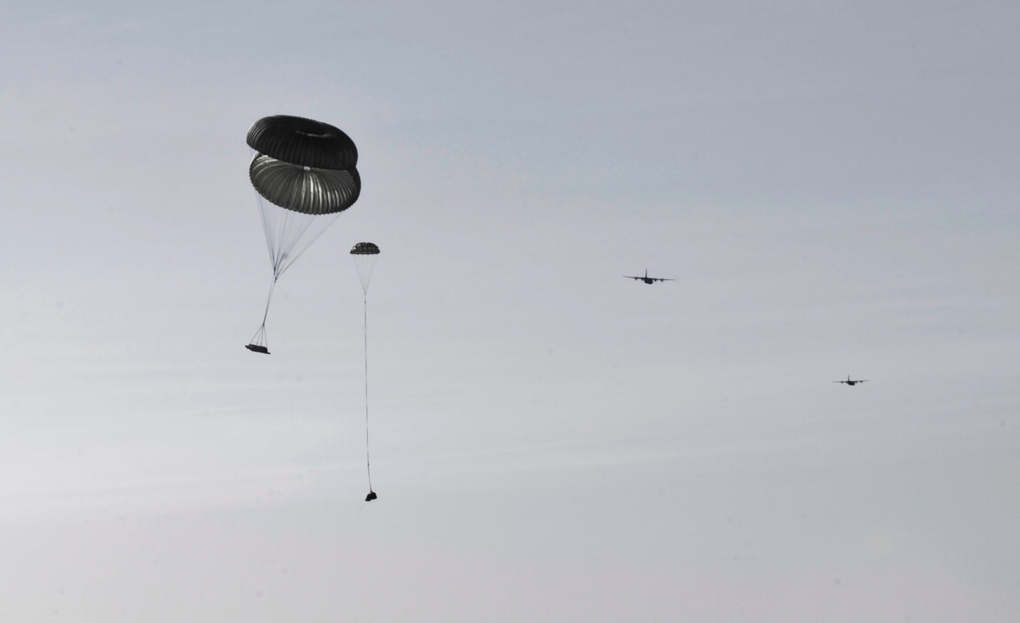 A C-130J releases an airdrop bundle during Impact Day Oct. 19, 2012, at Dyess Air Force, Texas. Maintainers from the 317th Airlift Group learned the outcome of generating an aircraft when it flies and resupplies a drop zone. (U.S. Air Force photo by Airman 1st Class Jonathan Stefanko/ Released)
