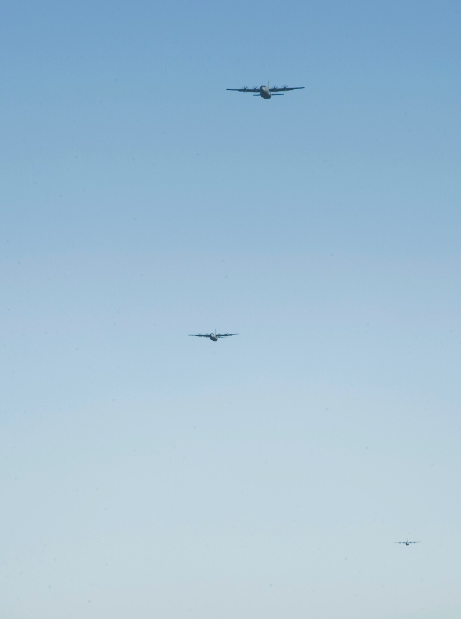 C-130Js fly toward a landing strip during Impact Day Oct. 19, 2012, at Dyess Air Force, Texas. Maintainers from the 317th Airlift Group learned the outcome of generating an aircraft when it flies and resupplies a drop zone. (U.S. Air Force photo by Airman 1st Class Jonathan Stefanko/ Released)