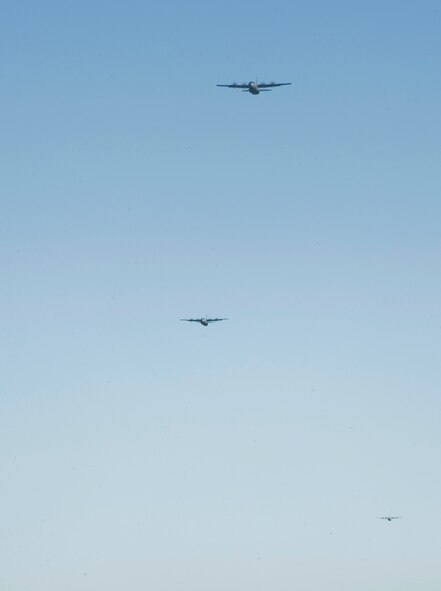 C-130Js fly toward a landing strip during Impact Day Oct. 19, 2012, at Dyess Air Force, Texas. Maintainers from the 317th Airlift Group learned the outcome of generating an aircraft when it flies and resupplies a drop zone. (U.S. Air Force photo by Airman 1st Class Jonathan Stefanko/ Released)
