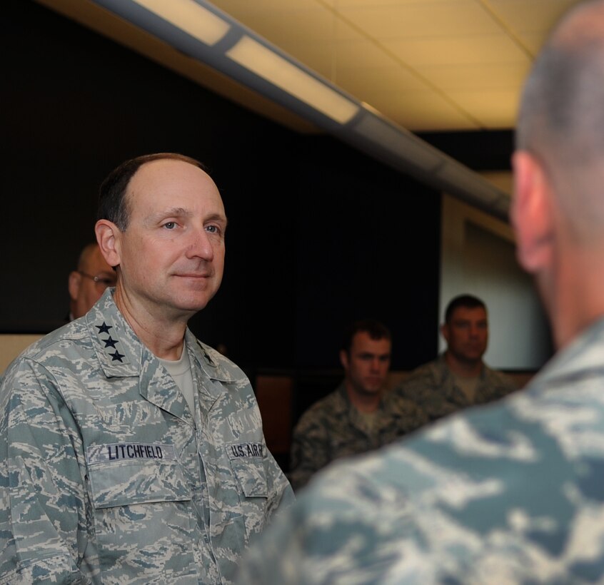 U.S. Air Force Lt. Gen. Bruce Litchfield, commander of the Air Force Sustainment Center, listens to Senior Master Sgt. Dwayne Hill, 439th Supply Chain Operations Squadron centralized repair facility flight chief, during a briefing at the 735th Supply Chain Operations Group on Langley Air Force Base, Va., Oct. 24, 2012.  Litchfield visited the 735th SCOG to discuss the impact it has on the Air Force. (U.S. Air Force photo by Senior Airman Racheal Watson/Released)