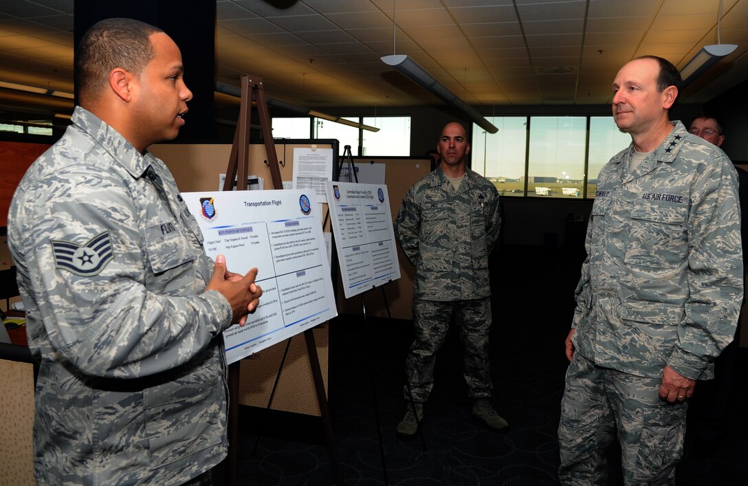 U.S. Air Force Staff Sgt. Eugene Floyd, 439th Supply Chain Operations Squadron transportation flight noncommissioned officer in charge, briefs Lt. Gen. Bruce Litchfield, commander of the Air Force Sustainment Center, during his visit to the 735th Supply Chain Operations Group at Langley Air Force Base, Va., Oct. 24, 2012. Litchfield toured the 735th SCOG to better understand its daily operations. (U.S. Air Force photo by Senior Airman Racheal Watson/Released)