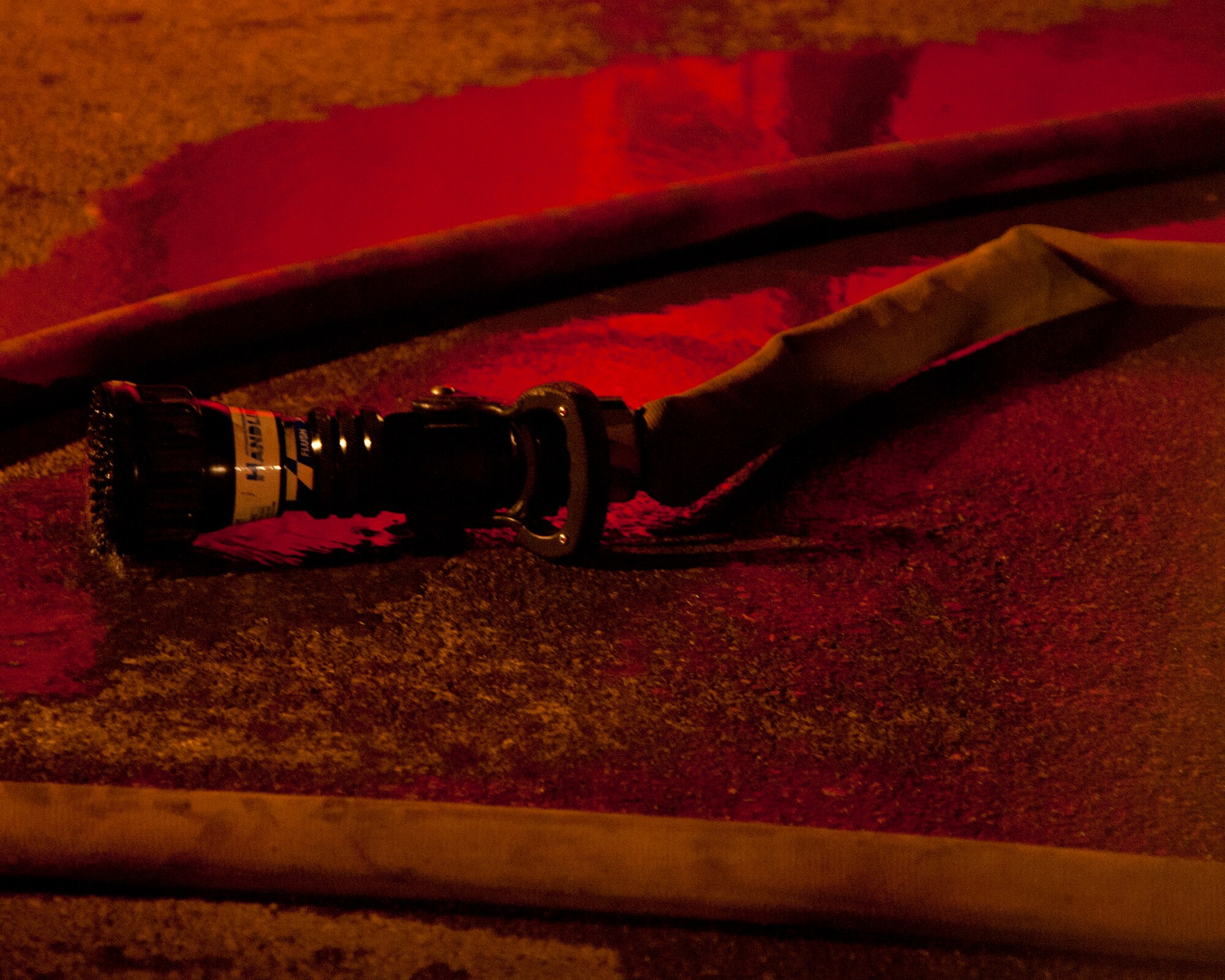 ALTUS AIR FORCE BASE, Okla. -- A fire hose drains water after being used to put out the embers of a fire in a vacant building on base Oct. 24, 2012. The 97th Civil Engineer Squadron fire department responded to the fire and extinguished it. The fire occurred in an unoccupied building that was in the process of being demolished. The cause is unknown at this time. (U.S. Air Force photo by Senior Airman Kenneth W. Norman / Released)