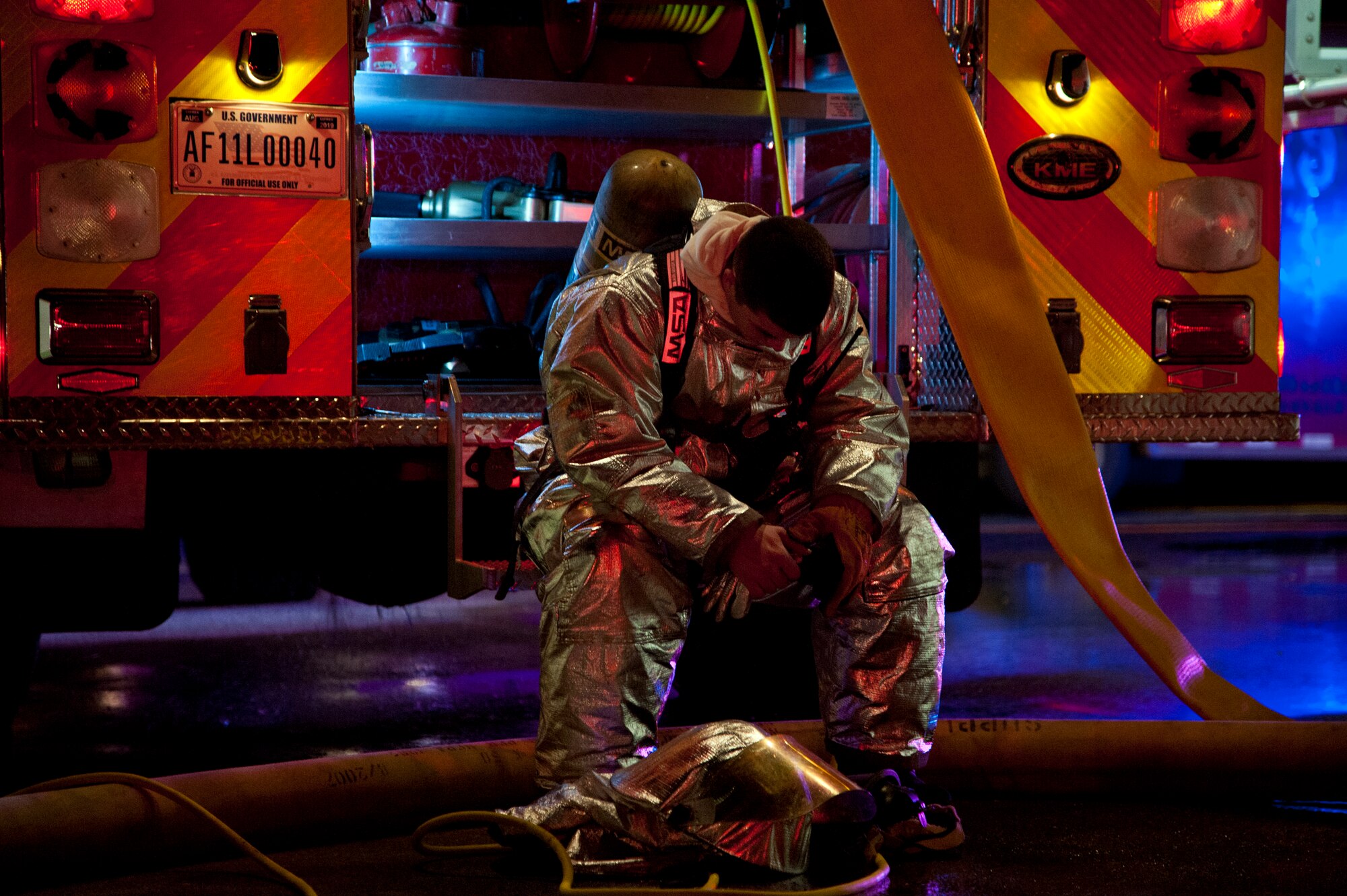 ALTUS AIR FORCE BASE, Okla. -- A firefighter from the 97th Civil Engineer Squadron fire department rests after battling a fire at a vacant building on base Oct. 24, 2012. The cause of the fire is unknown and it occurred in an unoccupied building that is currently in the process of being demolished. (U.S.  Air Force photo by Senior Airman Kenneth W. Norman / Released)