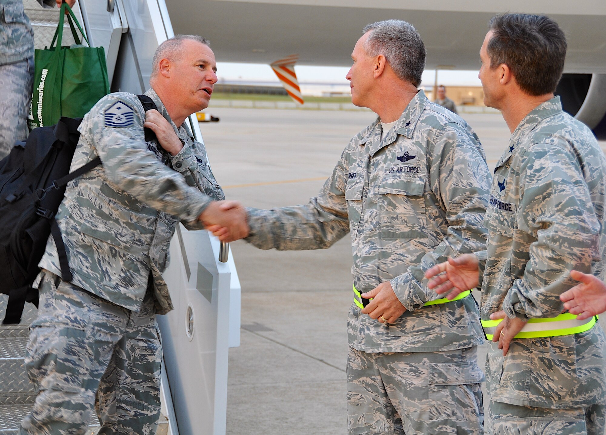 (left to right) Master Sgt. Anthony Garbarino, 301st Security Forces Squadron, is greeted by Brig. Gen. Bill Binger, 10th Air Force commander, and Brig. Gen Bruce Miller, 301st Fighter Wing commander, as he deplanes. More than 50 deployed members from the 301st Security Forces Squadron and 610th Security Forces Squadron, stationed at Naval Air Station Fort Worth Joint Reserve Base, Texas, returned Oct. 25, 2012. The members were deployed to Saudi Arabia for six months in support of Operation Enduring Freedom. A large group of 301st Fighter Wing family and friends gathered to welcome our returning Airmen home.