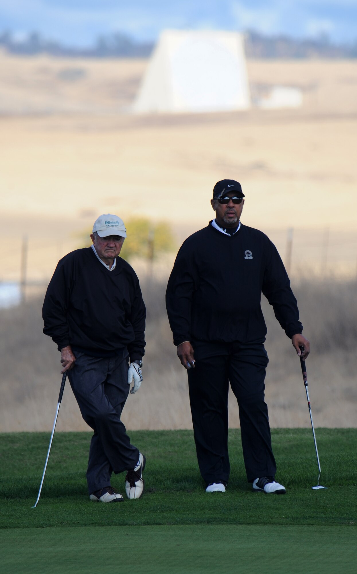 Jim Callahan and Doug Hill, 9th Force Support Squadron, take a break during the Intramural Golf Championships at the Coyote Run Golf Course Beale Air Force Base, Calif., Oct. 23, 2012. The 9th FSS was defeated by the 13th Intelligence Squadron. (U.S. Air Force photo by Staff Sgt. Robert M. Trujillo/Released)