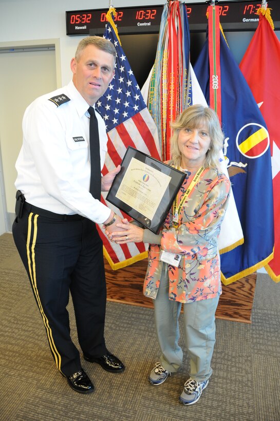 Lt. Gen. David Halverson, U.S. Army Training and Doctrine Command deputy commanding general, presents a certificate of appreciation to Renice Zimmerman, a Gold Star family member and Army veteran of Hampton Roads, Oct. 19 at TRADOC Headquarters. Halverson thanked Zimmerman for her mentorship of wounded warriors assigned to the Warrior Transition Unit located on Fort Eustis. A total of eight civilian mentors received recognition for their volunteer efforts with Soldiers of the WTU. (U.S. Army photo by Sgt. 1st Class Kelly Jo Bridgwater / TRADOC Public Affairs)