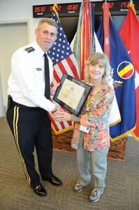 Lt. Gen. David Halverson, U.S. Army Training and Doctrine Command deputy commanding general, presents a certificate of appreciation to Renice Zimmerman, a Gold Star family member and Army veteran of Hampton Roads, Oct. 19 at TRADOC Headquarters. Halverson thanked Zimmerman for her mentorship of wounded warriors assigned to the Warrior Transition Unit located on Fort Eustis. A total of eight civilian mentors received recognition for their volunteer efforts with Soldiers of the WTU. (U.S. Army photo by Sgt. 1st Class Kelly Jo Bridgwater / TRADOC Public Affairs)