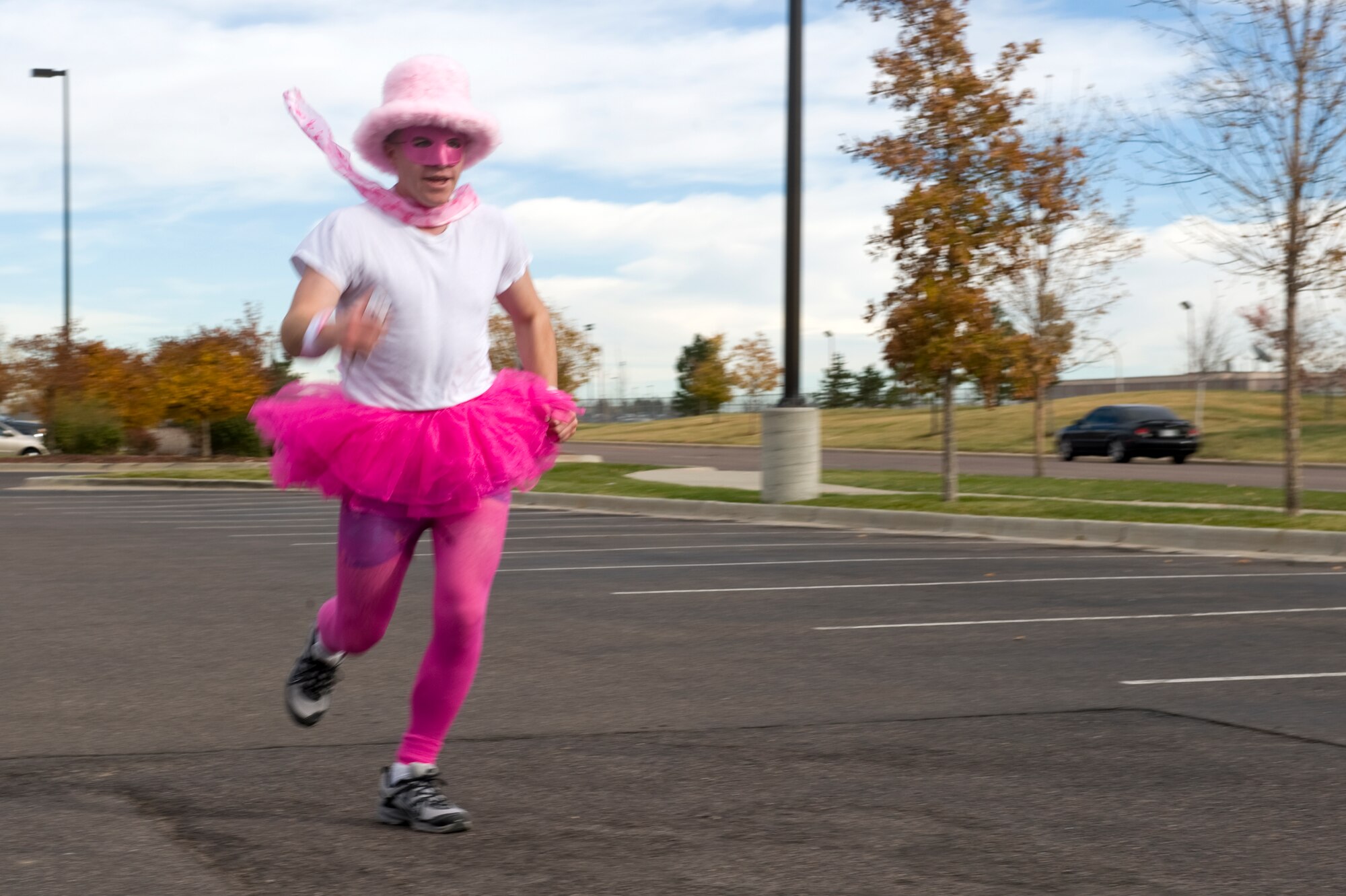 BUCKLEY AIR FORCE BASE, Colo. – Airman 1st Class Riley Jackson, 2nd Space Warning Squadron, dashes across the finish line of the Breast Cancer Awareness 5K Run/Walk Oct. 19, 2012, near the fitness center. Many racers donned pink attire to show their support for breast cancer awareness. (U.S. Air Force photo by Airman 1st Class Riley Johnson)