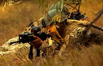 MINOT AIR FORCE BASE, N.D. - Staff Sgt. Matthew Henry, 791st Missile Security Forces Squadron member, looks through the scope of his rifle during a convoy response force exercise conducted here, Oct. 23. Response teams had the opportunity to test the effectiveness of two sets of Air Force uniforms on natural terrain during the exercise. (U.S. Air Force photo/Airman 1st Class Andrew Crawford)