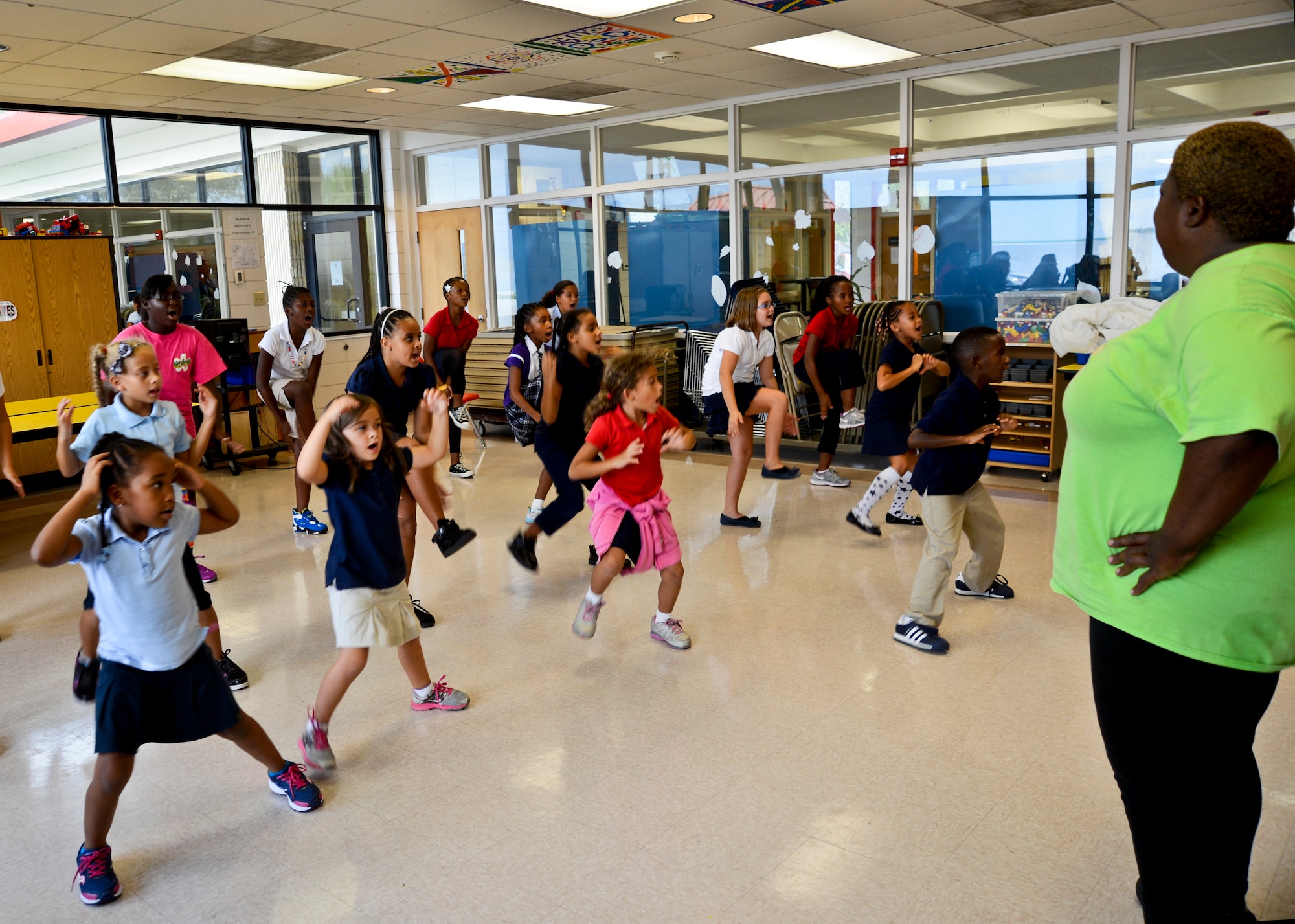 Felicia David, school age program assistant, observes a routine executed by the Grenades 4-H school age step team during practice Oct. 4, 2012, at MacDill Air Force Base, Fla. The Grenades represented MacDill AFB at the 2011 Florida State Fair and have won numerous 4-H county and district competitions. (U.S Air Force photo by Airman 1st Class Melanie Bulow-Kelly/Released)