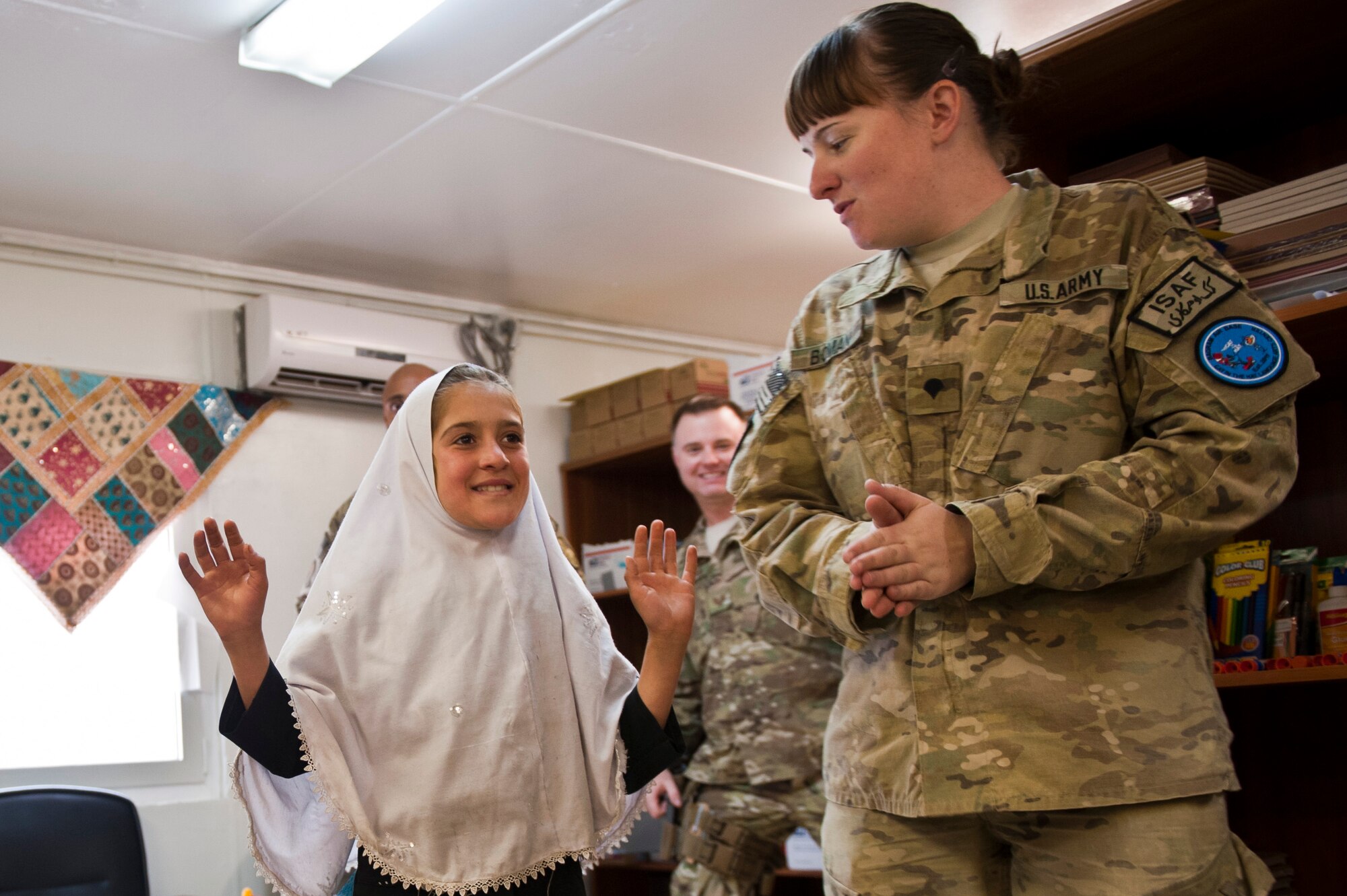 An Afghan student learns the “Hokey-Pokey” dance during a “Cat in the Hat” education session at Bagram Airfield, Afghanistan, Oct. 14, 2012. The educational outreach program supports the International Security Assistance Force’s counter-insurgency efforts by enabling positive interaction between U.S. service members and the local community. (U.S. Air Force photo/Capt. Raymond Geoffroy)