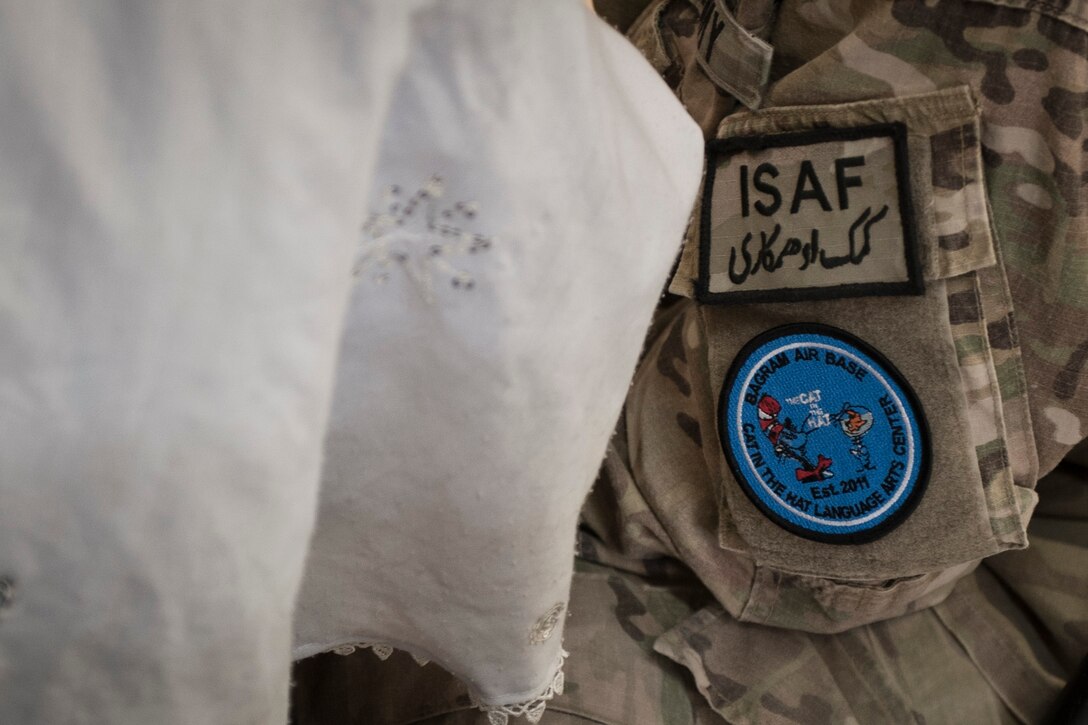An Afghan student and Bagram volunteer review a lesson together during a “Cat in the Hat” education session at Bagram Airfield, Afghanistan, Oct. 14, 2012. The program is a volunteer-run community outreach effort designed to provide local Afghan children a safe, nurturing learning environment in which they are inspired to bring positive change to Afghanistan. (U.S. Air Force photo/Capt. Raymond Geoffroy)