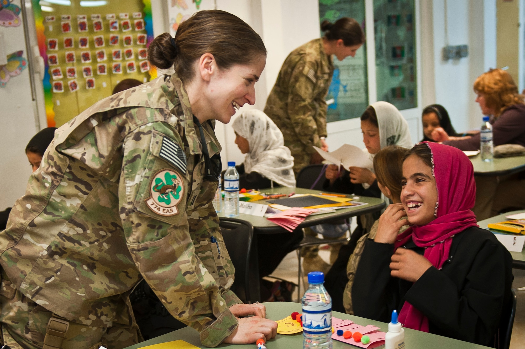 Yagana, a local Afghan student, laughs with Capt. Rachel Seablom, a volunteer from the 774th Expeditionary Airlift Squadron, during a “Cat in the Hat” education session at Bagram Airfield, Afghanistan, Oct. 14, 2012. The program is a volunteer-run community outreach effort designed to provide local Afghan children a safe, nurturing learning environment in which they are inspired to bring positive change to Afghanistan. (U.S. Air Force photo/Capt. Raymond Geoffroy)