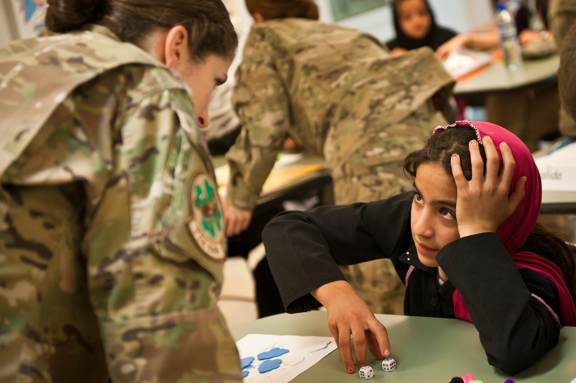 Yagana, a local Afghan student, plays a counting game with Capt. Rachel Seablom, a volunteer from the 774th Expeditionary Airlift Squadron, during a “Cat in the Hat” education session at Bagram Airfield, Afghanistan, Oct. 14, 2012. The program is a volunteer-run community outreach effort designed to provide local Afghan children a safe, nurturing learning environment in which they are inspired to bring positive change to Afghanistan. (U.S. Air Force photo/Capt. Raymond Geoffroy)