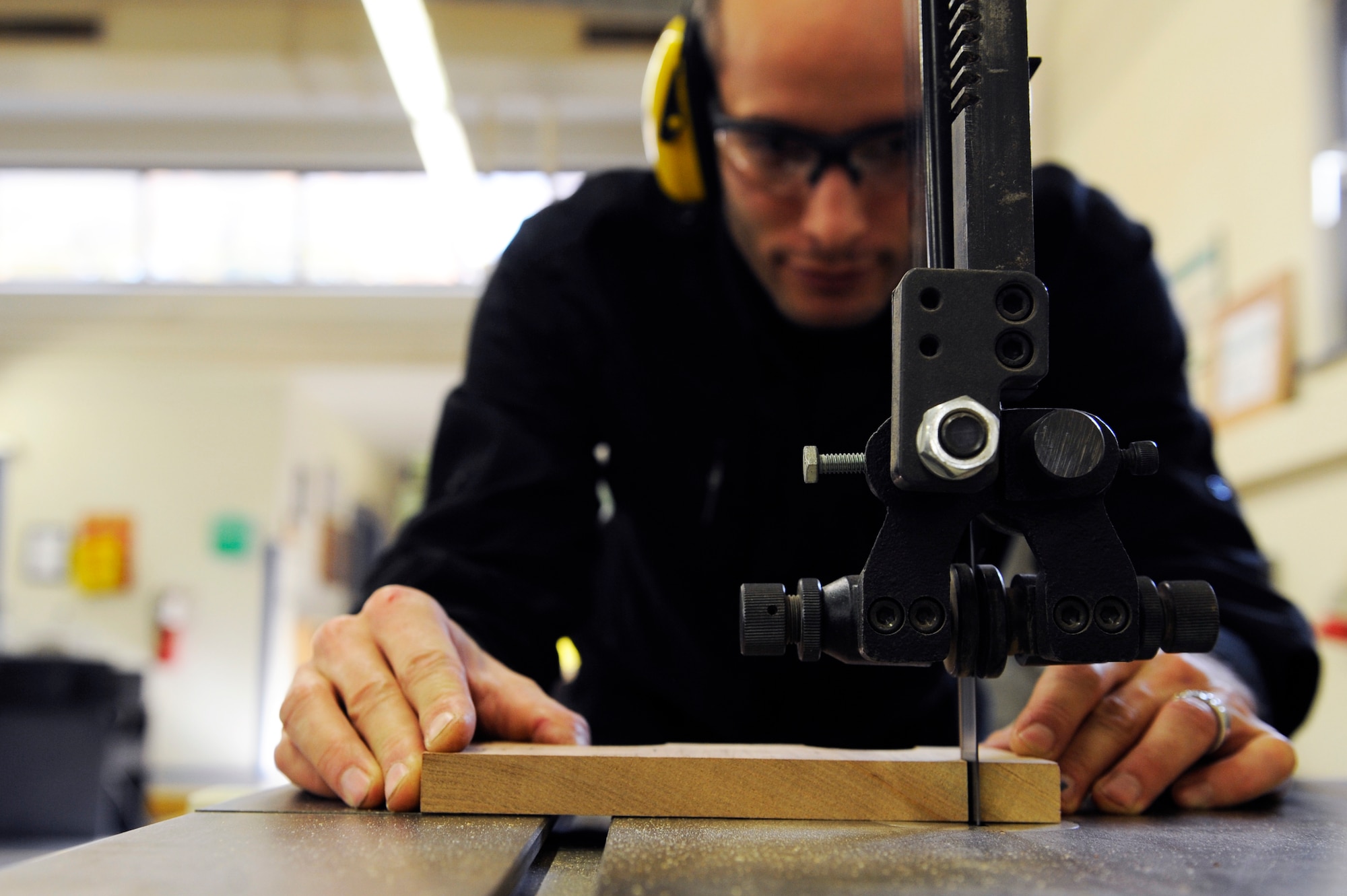 Kevin Sibbald, woodcrafter, uses a band saw to cut wood at the wood shop on Ramstein Air Base, Germany, Oct. 24, 2012. The wood shop is located at the Northside Fitness Center across from the Arts and Craft shop. Classes are scheduled to resume in January. (U.S. Air Force photo/Senior Airman Aaron-Forrest Wainwright)