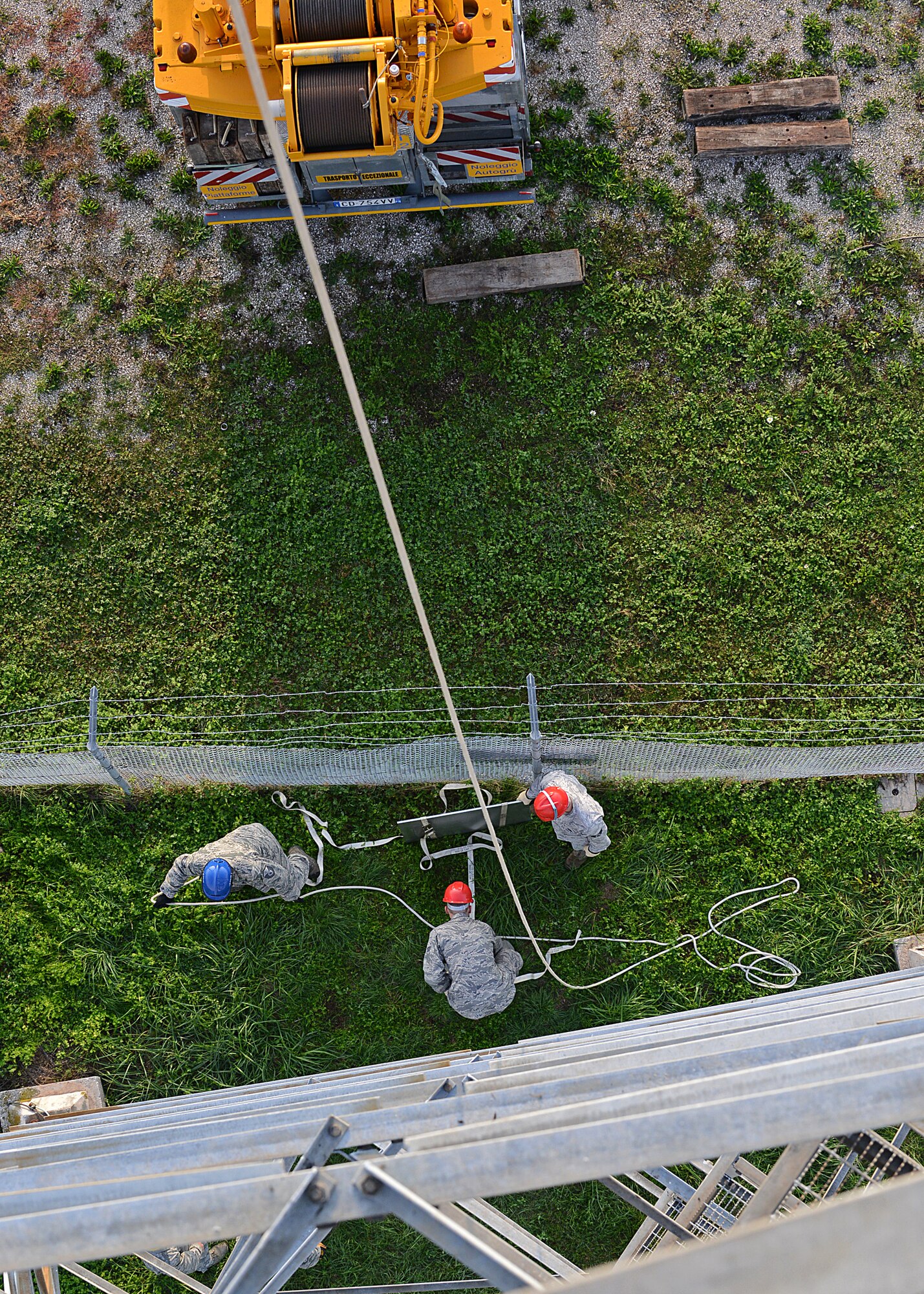 Airmen assigned to Aviano Air Base's 31st Communications Squadron and Ramstein Air Base's 1st Communications Maintenance Squadron prepare to hoist a mounting plate onto a weathertower at Aviano Oct. 18, 2012.  The new Portable Doppler Radar system replaces the Tactical Weather System, which is no longer supported by the Air Force.(U.S. Air Force photo by Staff Sgt. Ryan Whitney)